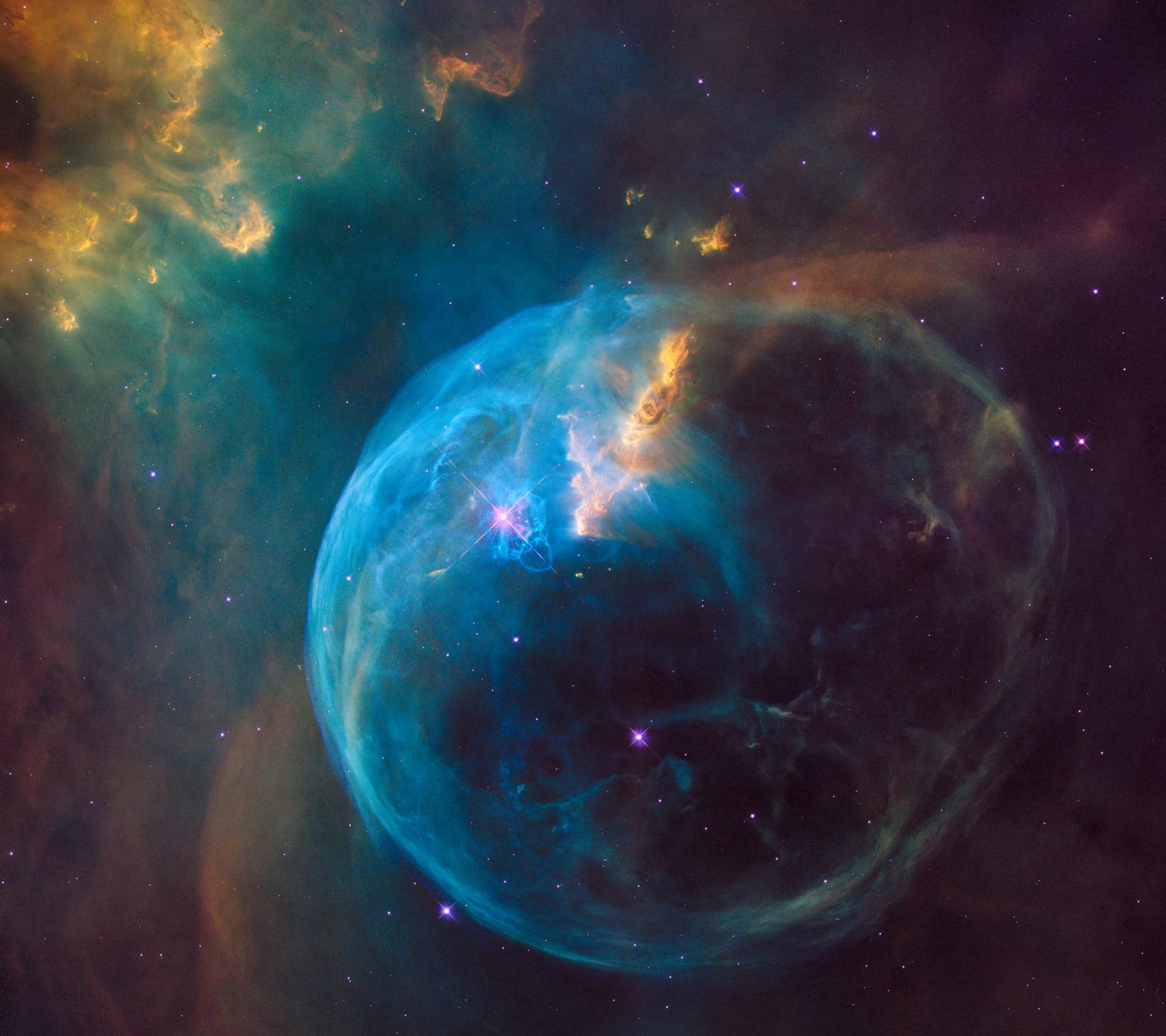 外太空 桌布 壁紙 — 一個充滿活力的宇宙泡泡星雲，在星空中發出電藍色和火橙色氣體的光芒。
