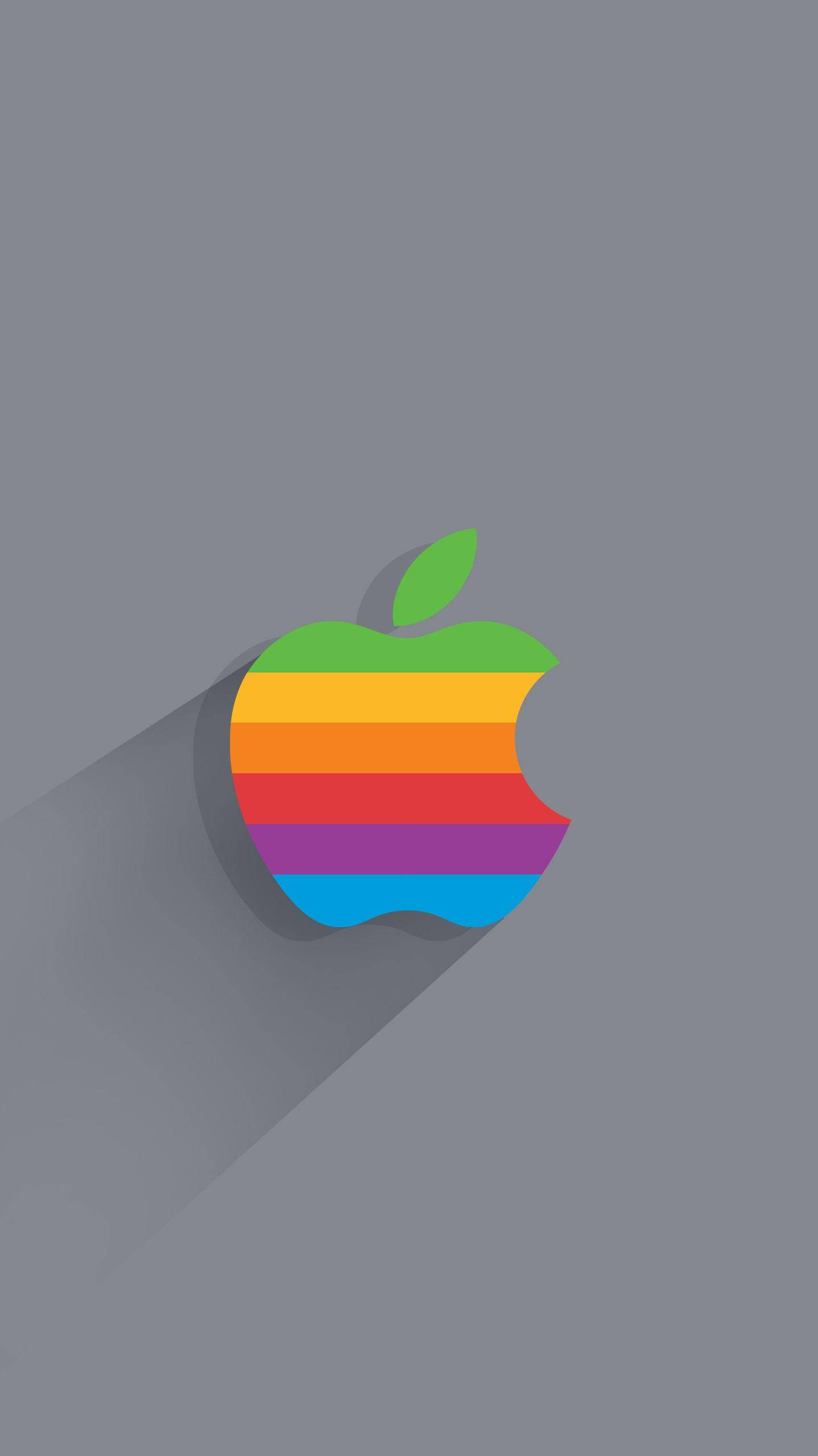 iPhone 桌布 壁紙 — 一個充滿活力的彩虹條紋蘋果標誌，帶有綠色葉子，在柔和的灰色背景上投下長長的陰影。