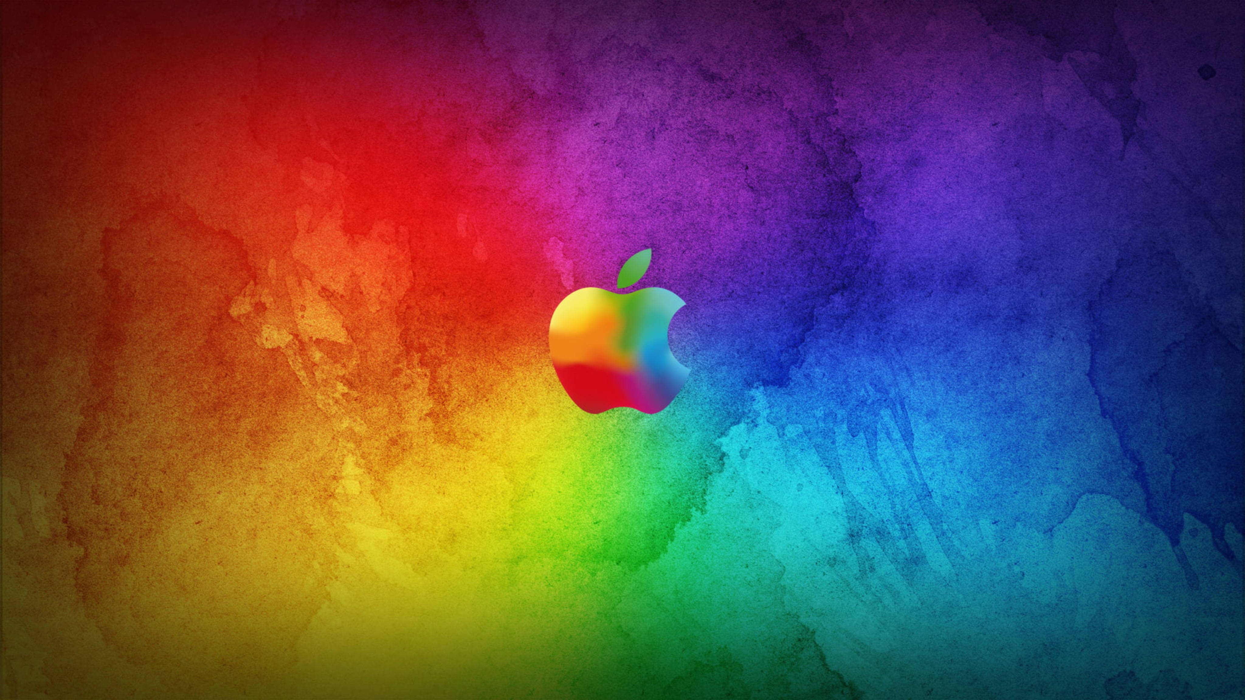 Apple 4K Ultra HD 桌布 壁紙 — 一個充滿活力的彩虹水彩潑濺，中央有一個色彩繽紛的Apple標誌，背景是紋理漸變。