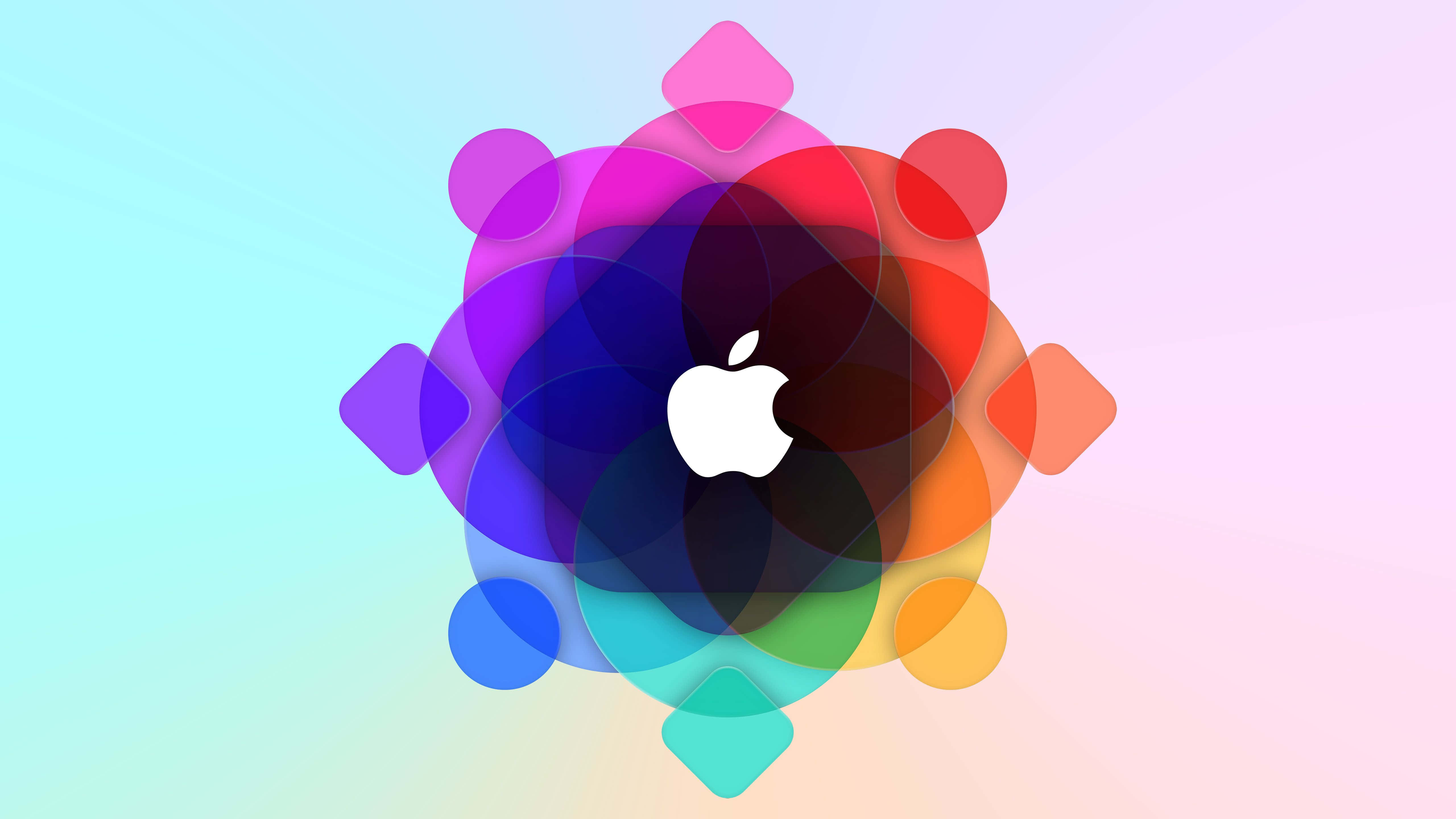Apple 4K 桌布 壁紙 — 一個充滿活力的抽象設計，以重疊的彩色形狀從中央的白色Apple標誌向四周輻射，背景為柔和的漸變色。