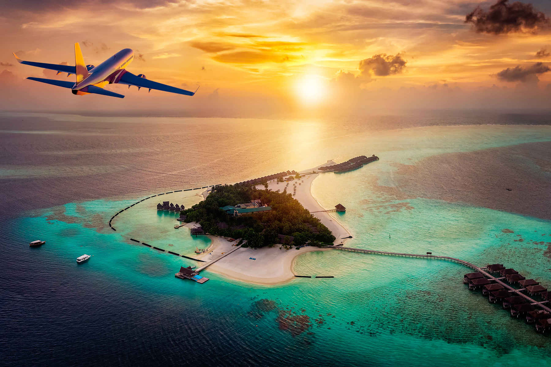 Travel Desktop 桌布 壁紙 — 一個充滿活力的日落，在一個熱帶島嶼上，有碧綠的海水和一架飛機飛過。
