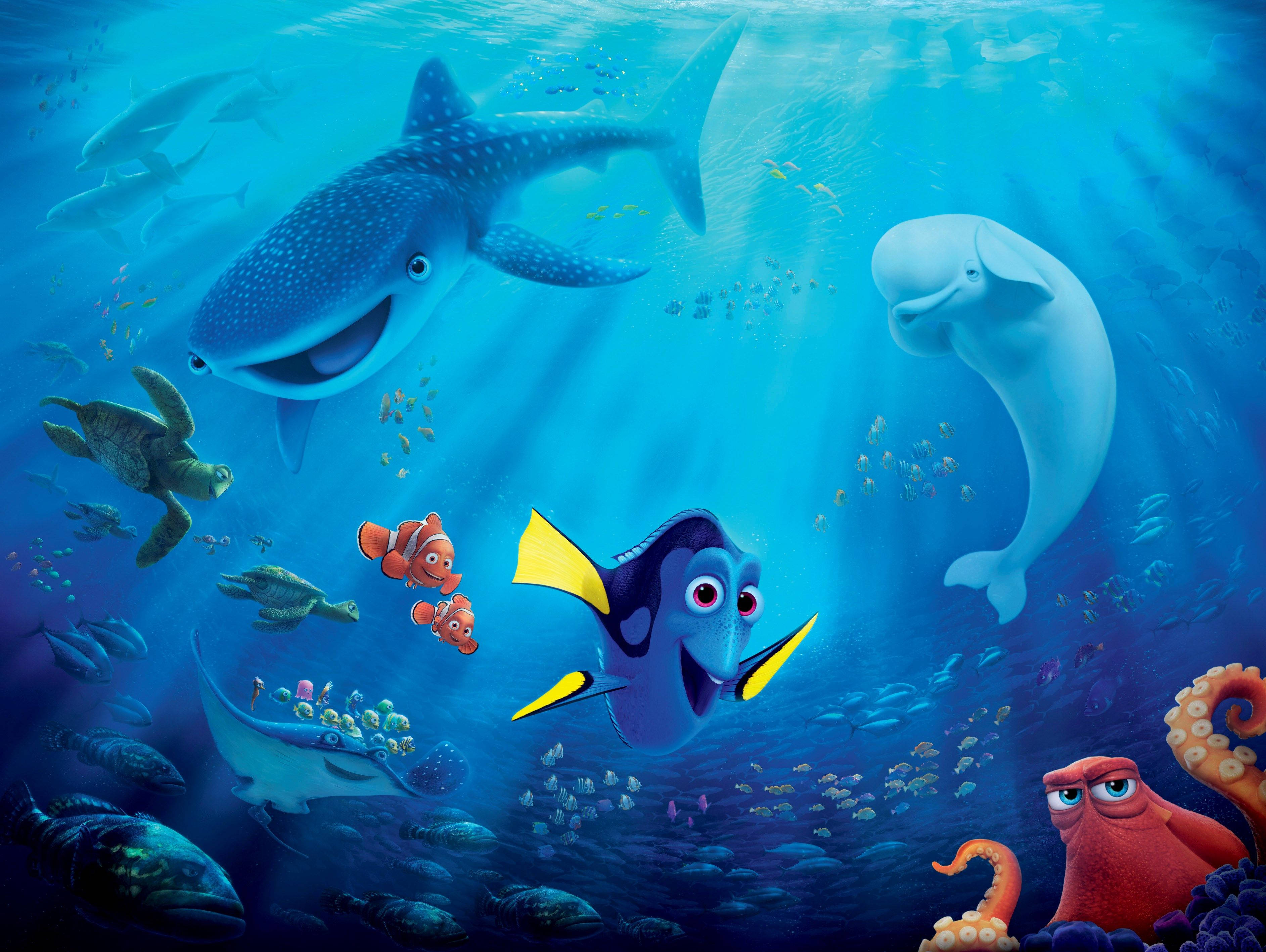 nemo 桌布 壁紙 — 一個充滿活力的海底場景，多莉和尼莫與鯨鯊、白鯨及其他海洋生物在陽光照耀的藍色海水中暢游。