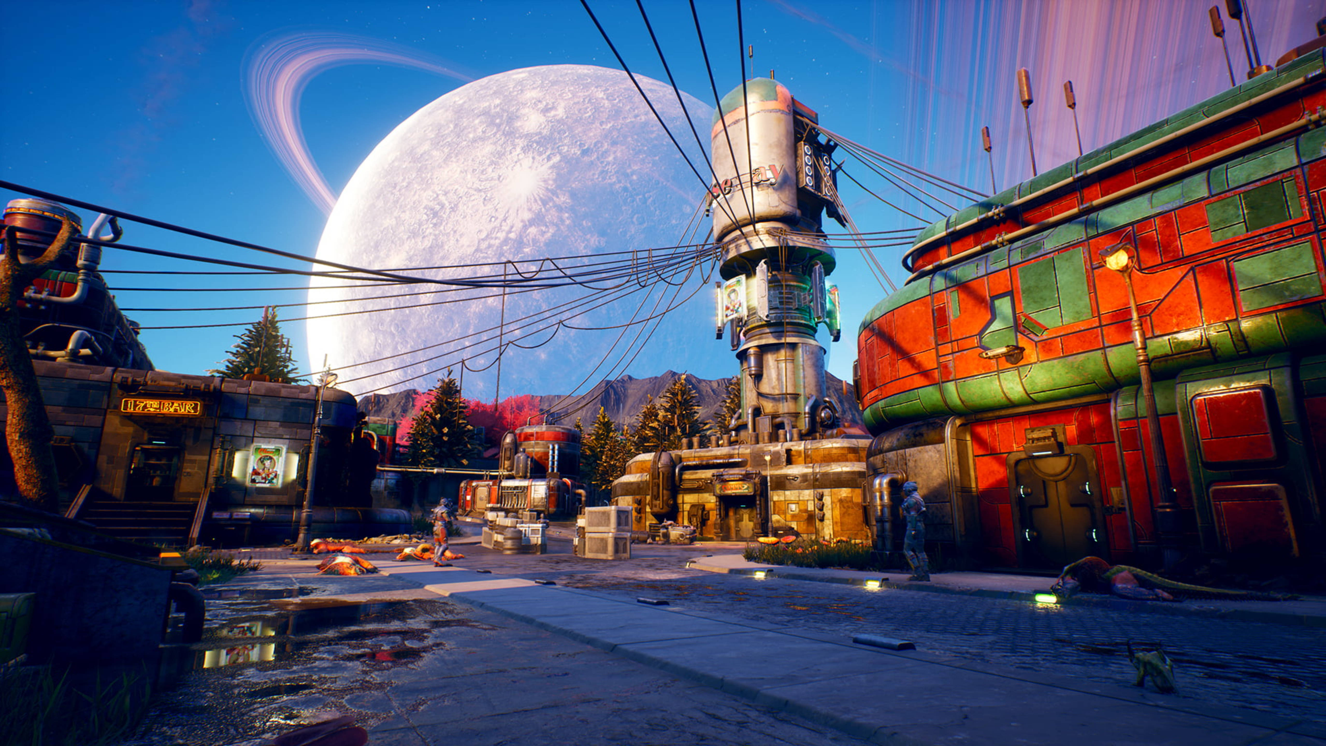 Outer Worlds 桌布 壁紙 — 一個充滿活力的科幻小鎮，在日落時分，巨大的環狀月亮下，色彩繽紛的復古未來主義建築。