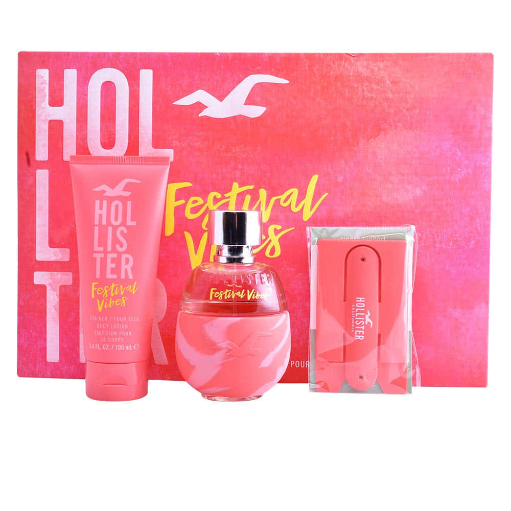 Hollister 桌布 壁紙 — 一個充滿活力的粉紅色Hollister Festival Vibes禮品套裝，包含香水、身體乳液和一把粉紅色刮鬍刀，放置在帶有海鷗標誌的紋理粉紅色盒子中。