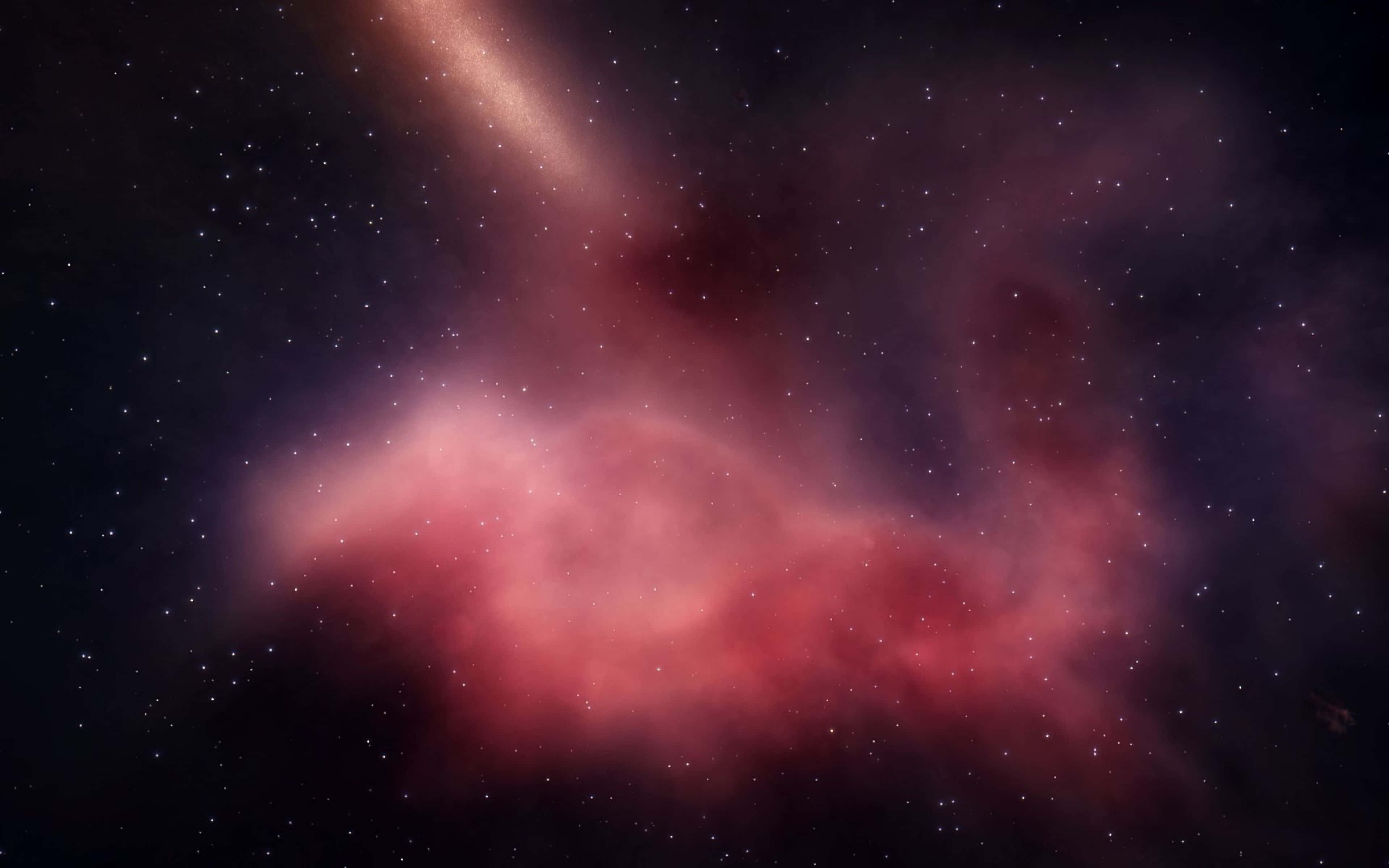 Space Nebula 桌布 壁紙 — 一個充滿活力的粉紅色星雲在深邃的太空中旋轉，點綴著無數閃爍的星星和一條發光的銀河帶。