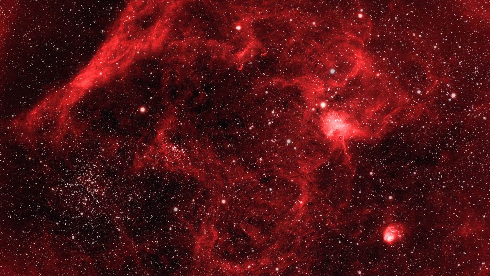 Red Space 桌布 壁紙 — 一個充滿活力的紅色星雲，在深邃的宇宙虛空中，伴隨著發光的氣體和散落的星星旋轉。