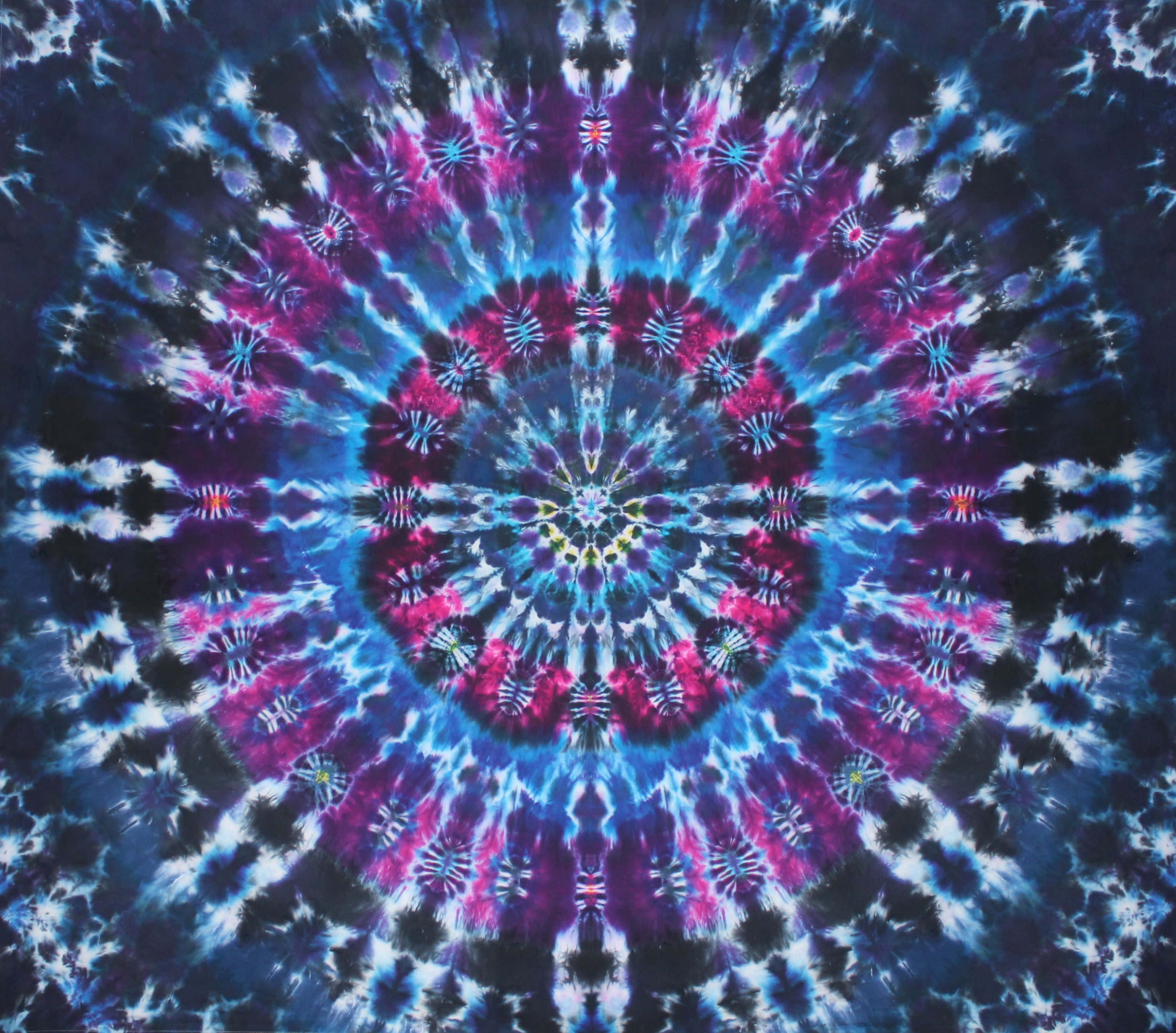 扎染 桌布 壁紙 — 一個充滿活力的紮染曼陀羅從中心點輻射出來，帶有電光藍、洋紅和黑色的對稱圖案。