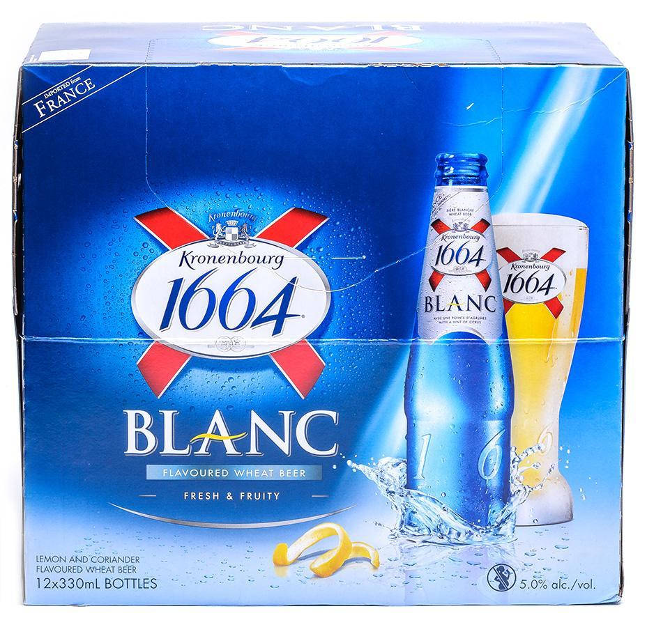 Beer Bottle 桌布 壁紙 — 一個充滿活力的藍色Kronenbourg 1664 Blanc啤酒盒，包含一瓶啤酒和一個杯子，帶有檸檬皮飛濺和露珠。