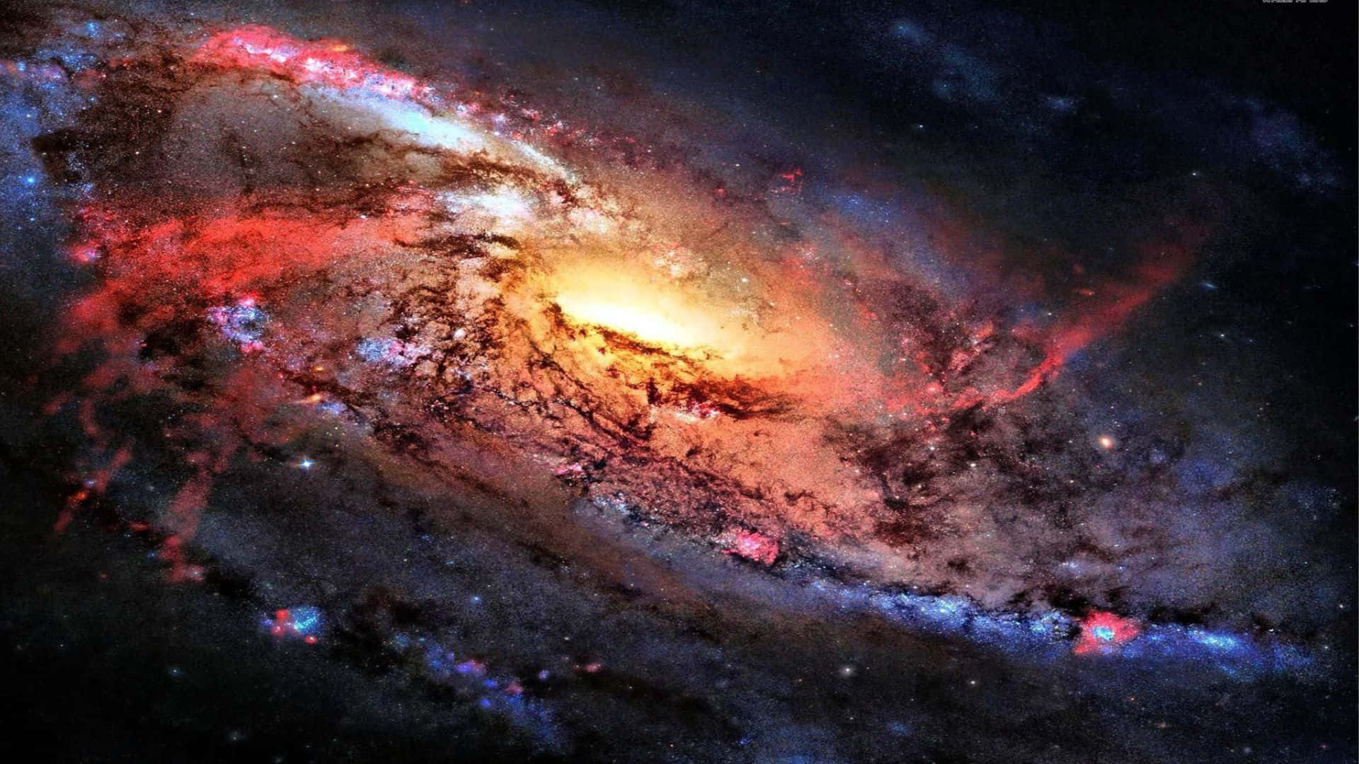 3d Galaxy 桌布 壁紙 — 一個充滿活力的螺旋星系，在繁星點點的宇宙虛空中旋轉，呈現出火紅、金色和冷藍色。