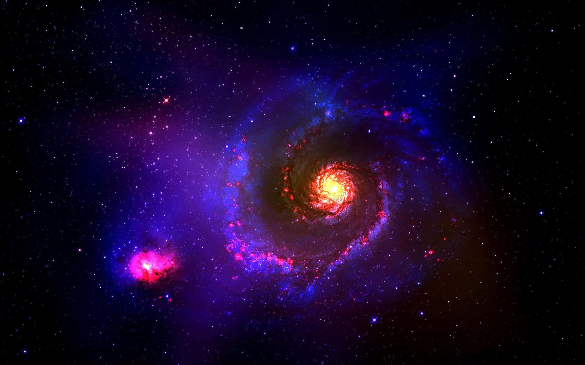 宇宙 桌布 壁紙 — 一個充滿活力的螺旋星系，帶有發光的紅色和藍色旋臂，在星空背景下旋轉。