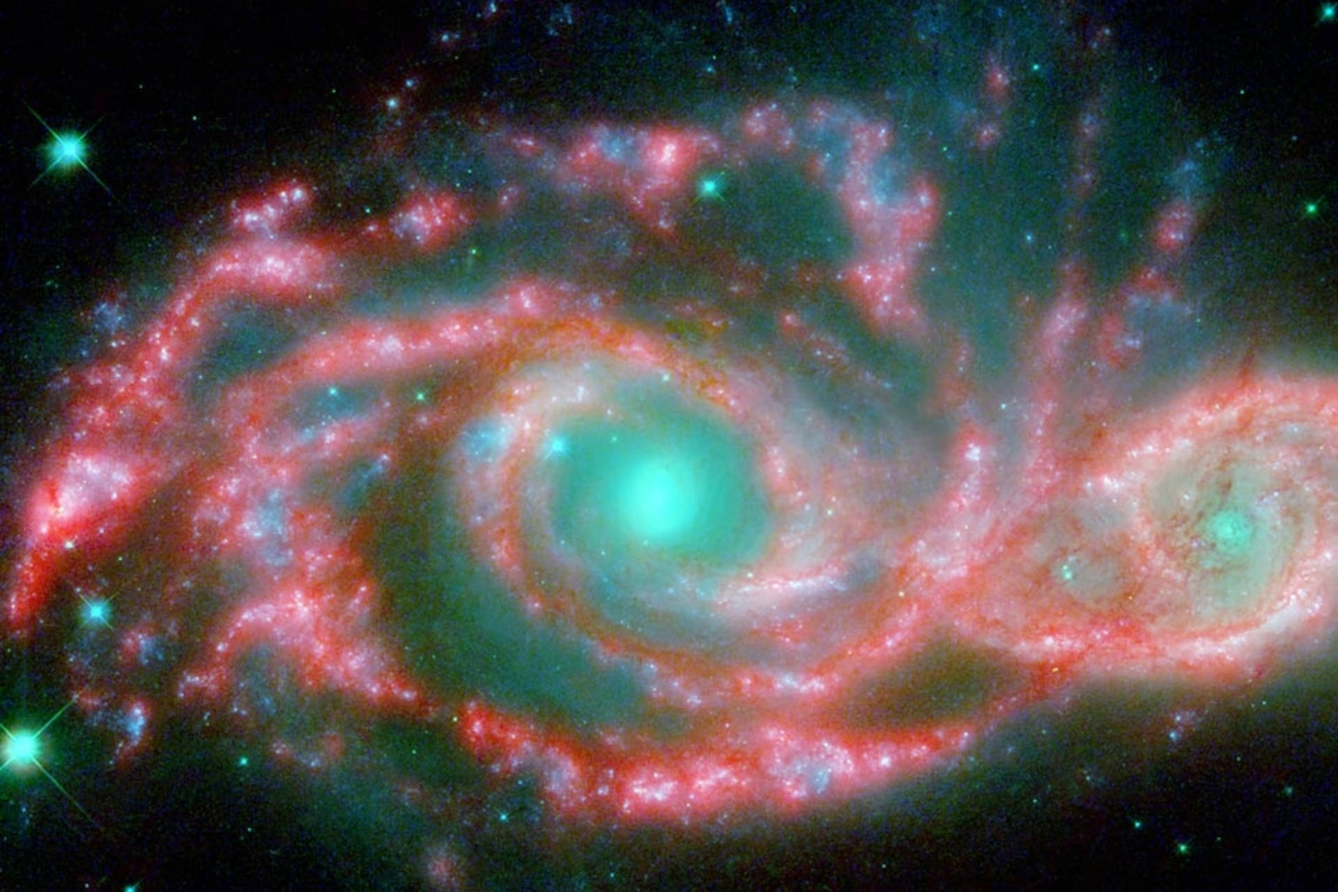 銀河 桌布 壁紙 — 一個充滿活力的螺旋星系在繁星點點的宇宙背景下旋轉著紅色和藍綠色的星雲。
