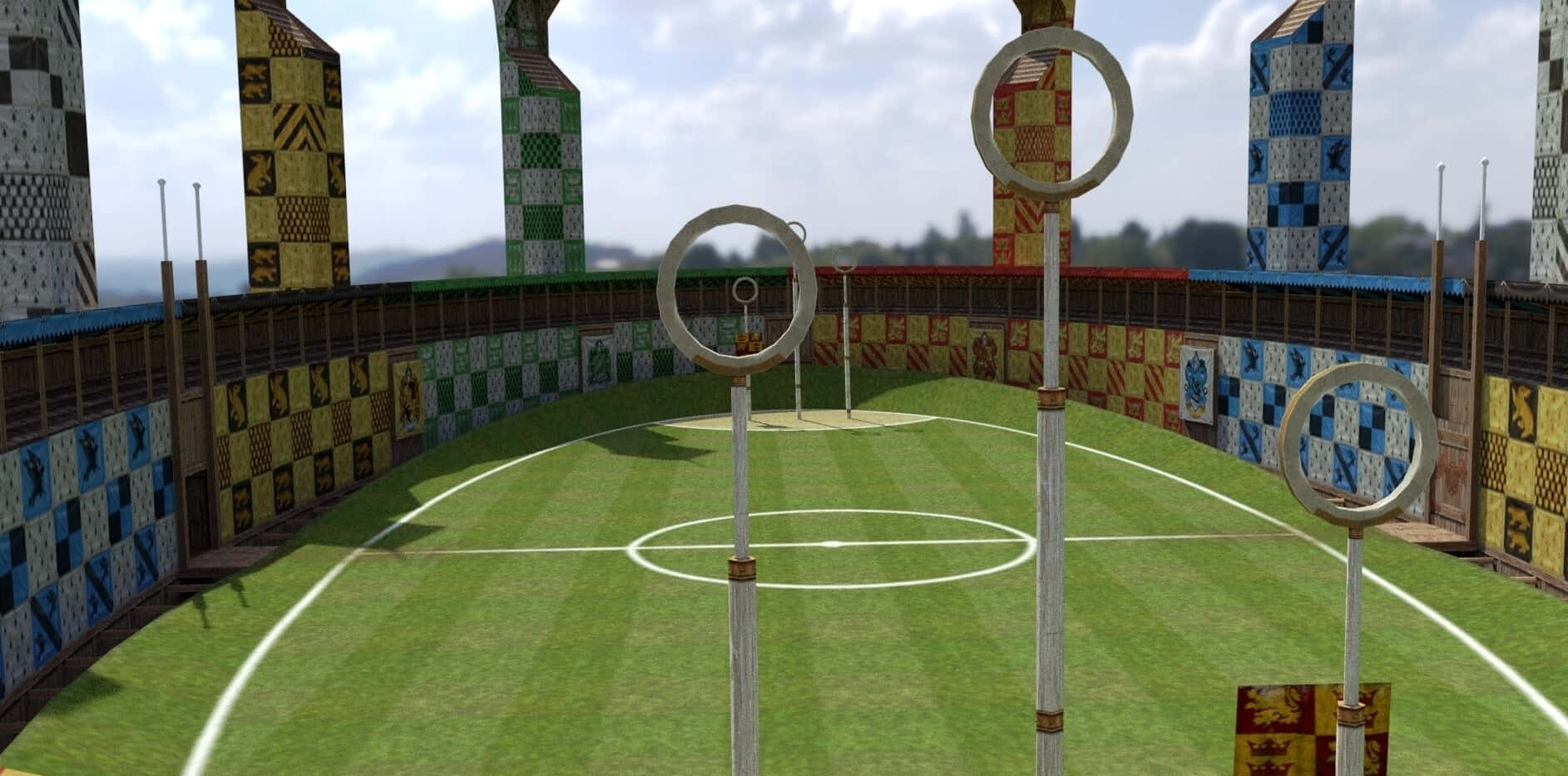 Quidditch 桌布 壁紙 — 一個充滿活力的魁地奇球場，設有三個圓環和魔法橫幅，在明亮的天空下。