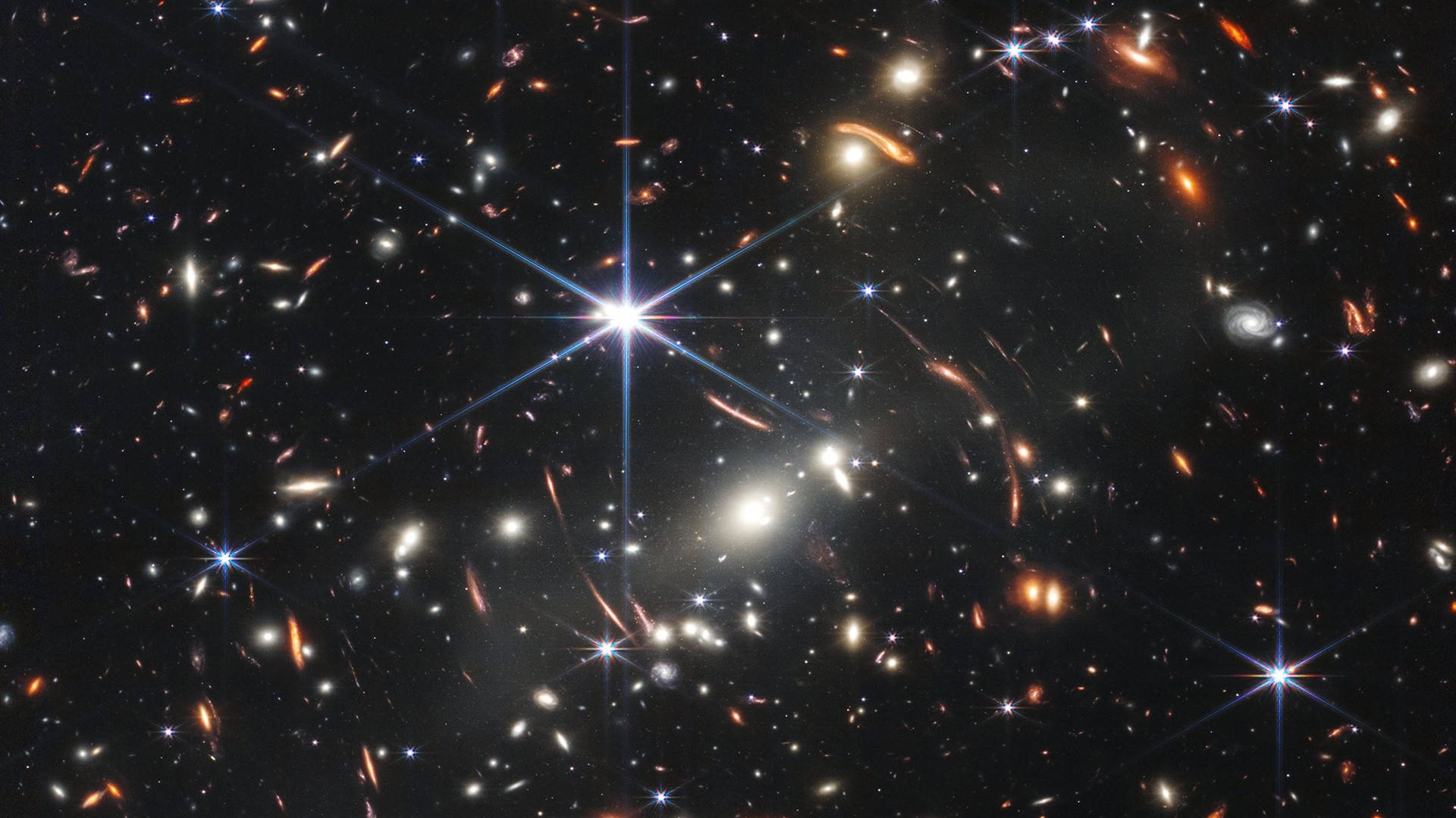 Stars 桌布 壁紙 — 一個充滿發光星系和璀璨恆星的宇宙景觀，背景是深邃的黑色虛空。