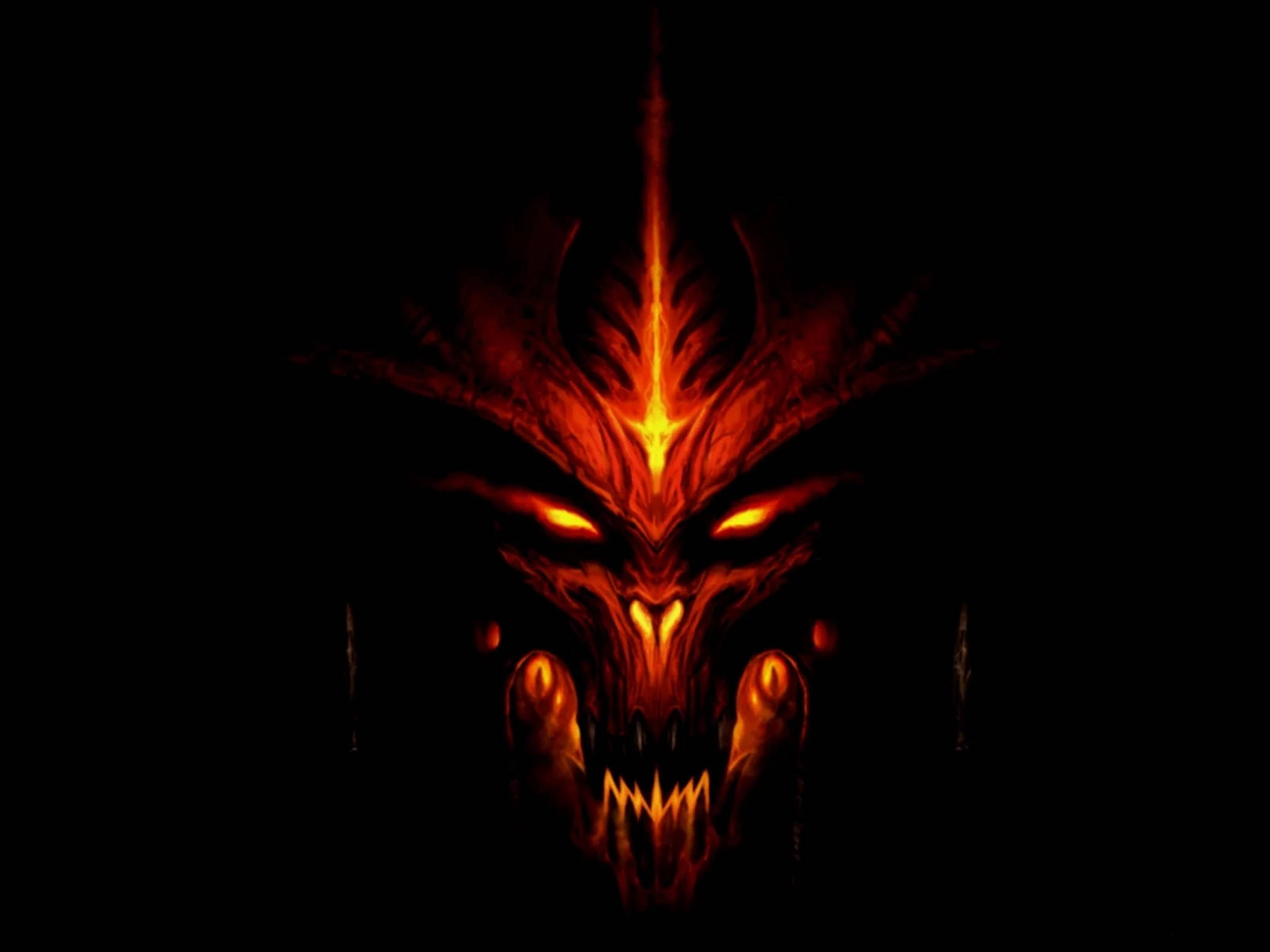 Profile 桌布 壁紙 — 一個兇惡的惡魔面孔在漆黑的背景上發出火熱的橙色和紅色光芒。