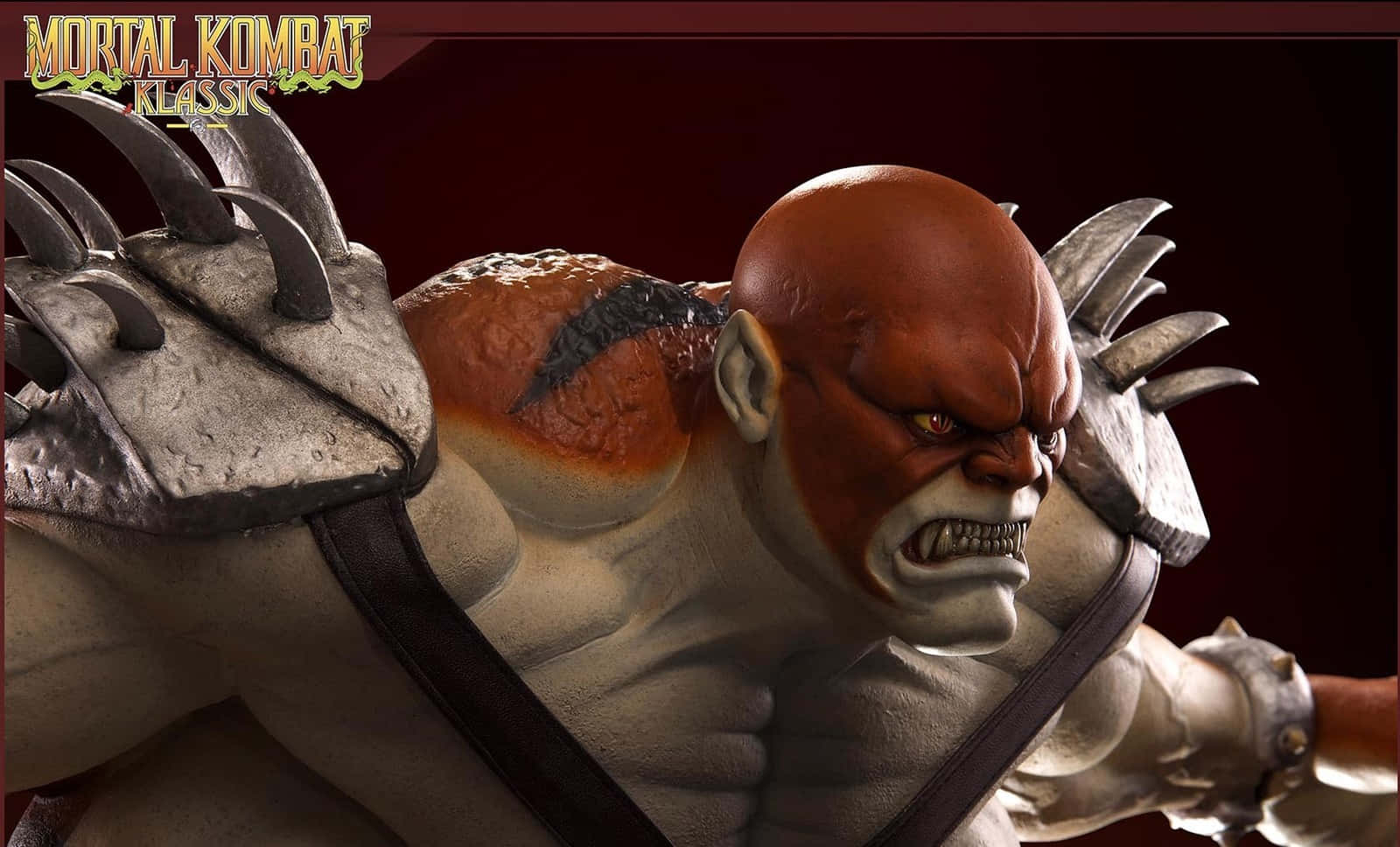 Mortal Kombat Kintaro 桌布 壁紙 — 一個兇猛、肌肉發達、紅皮膚、身穿尖刺盔甲的戰士在戲劇性的特寫鏡頭中咆哮。