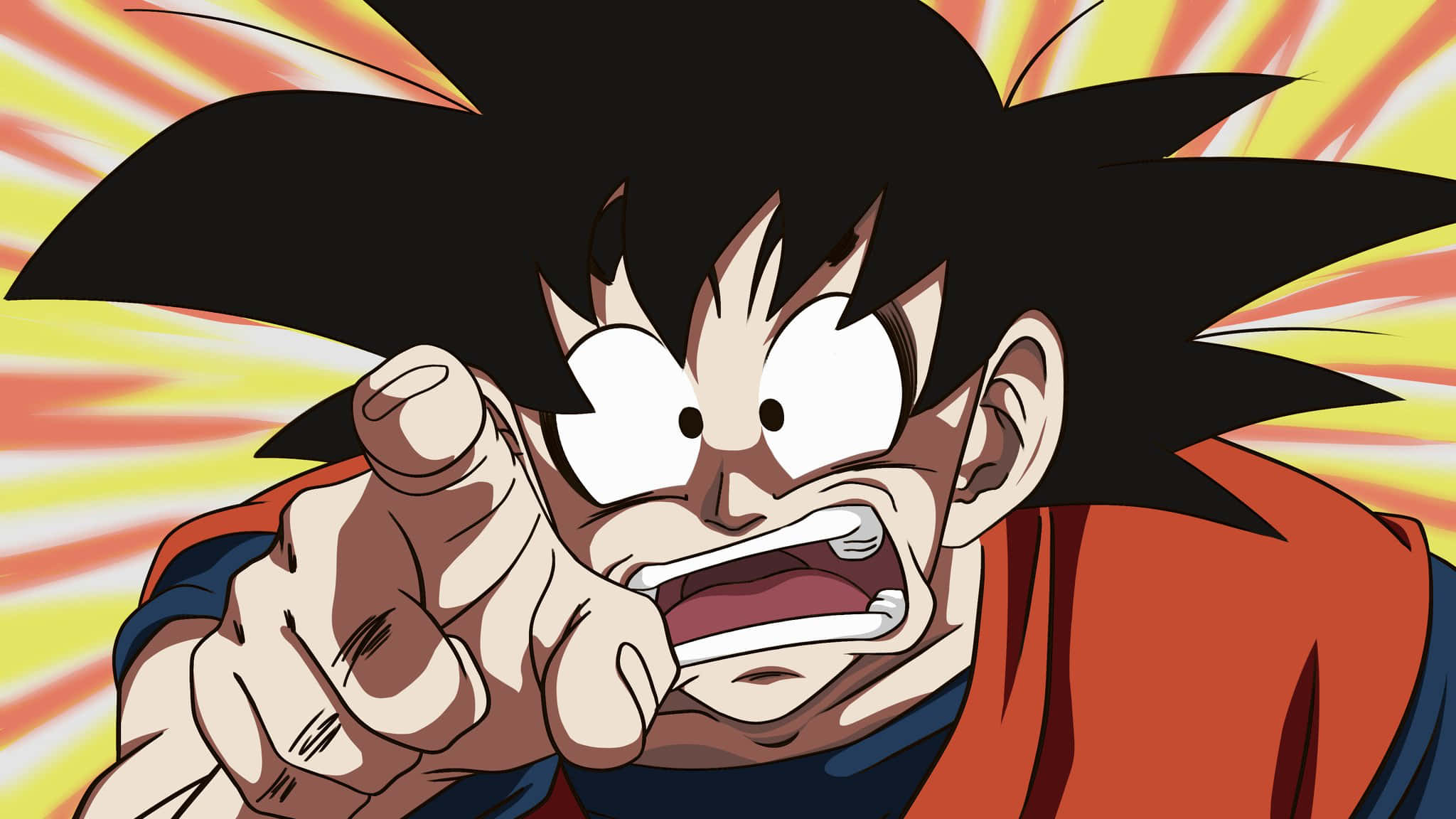 Funny Goku 桌布 壁紙 — 一個兇猛的動漫角色，有著尖刺般的黑髮，在燦爛的黃色和橙色背景下，帶著強烈的表情向前指著。