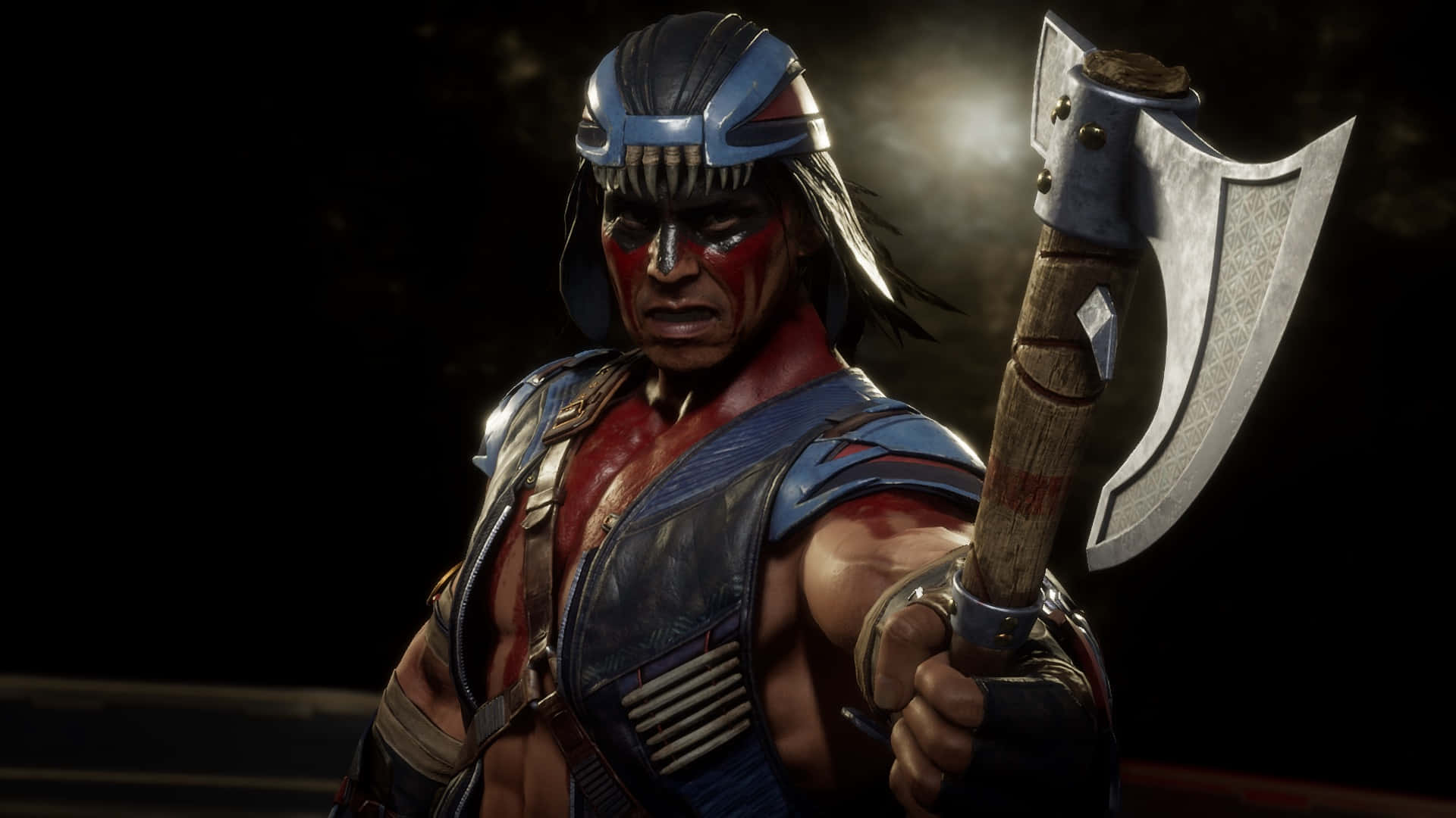 Mortal Kombat Nightwolf 桌布 壁紙 — 一個兇猛的戰士，臉上塗著紅色顏料，身穿藍色盔甲，在黑暗煙霧繚繞的背景中緊握戰斧。