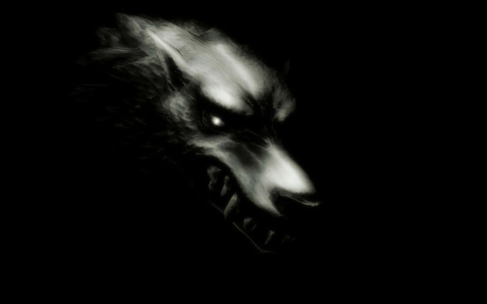 Angry Wolf 桌布 壁紙 — 一個兇猛的狼頭在漆黑虛空中散發詭異光芒，露出牙齒，無聲怒吼。