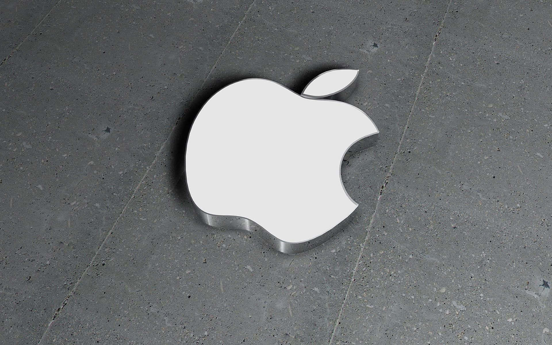 Best Apple 桌布 壁紙 — 一個光滑的白色Apple標誌放置在帶有紋理的灰色混凝土地板上，帶有柔和陰影。