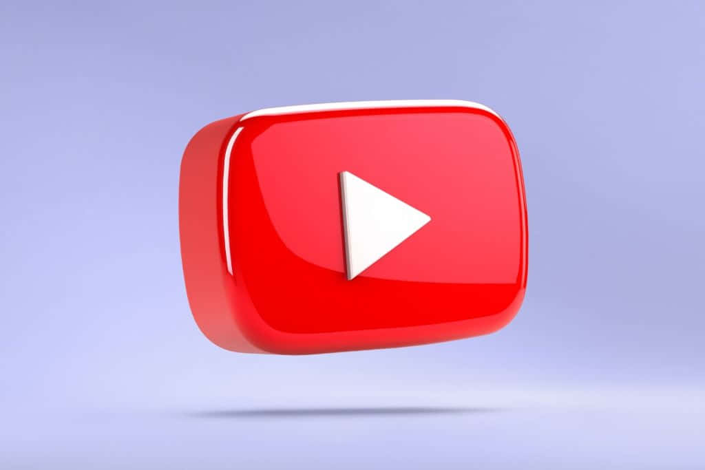 YouTube 桌布 壁紙 — 一個光滑的紅色 YouTube 播放按鈕圖示漂浮在柔和的薰衣草漸變背景上。