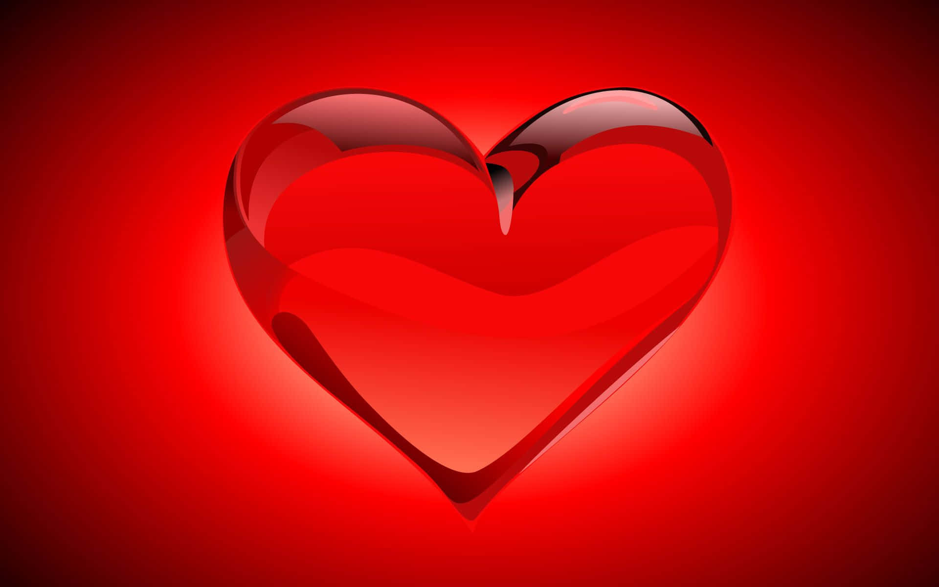 Red Heart 桌布 壁紙 — 一個光滑的紅色心形玻璃物體在帶有柔和光線的紅色漸變背景上發光。