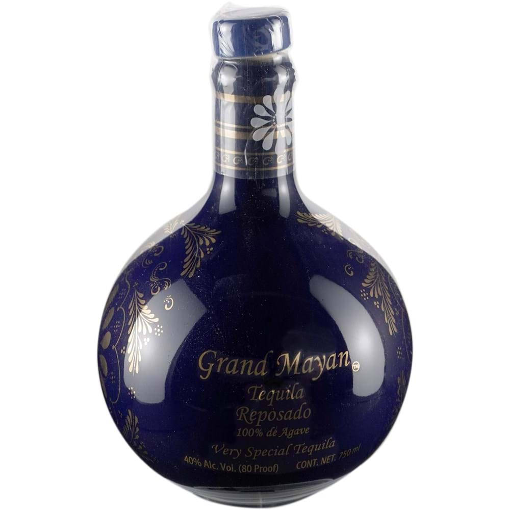 alcohol 桌布 壁紙 — 一個光澤的深藍色龍舌蘭酒瓶，帶有金色花卉圖案和優雅字體，背景為純白色。