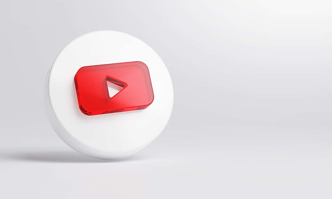 icon 桌布 壁紙 — 一個光澤的紅色 YouTube 播放按鈕圖示放在白色圓形底座上，背景是柔和的灰色漸變。