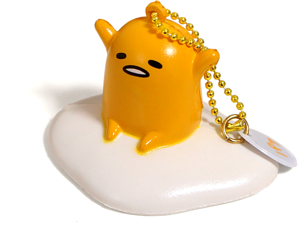蛋黃哥 桌布 壁紙 — 一個光澤的黃色Gudetama鑰匙圈放在白色蛋形底座上，背景為純黑色。