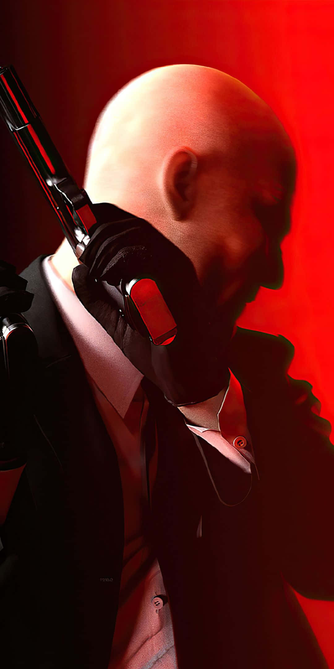 Pixel 3 Hitman Absolution 桌布 壁紙 — 一個光頭刺客穿著黑色西裝，在鮮紅色背景下將槍指著自己的太陽穴。
