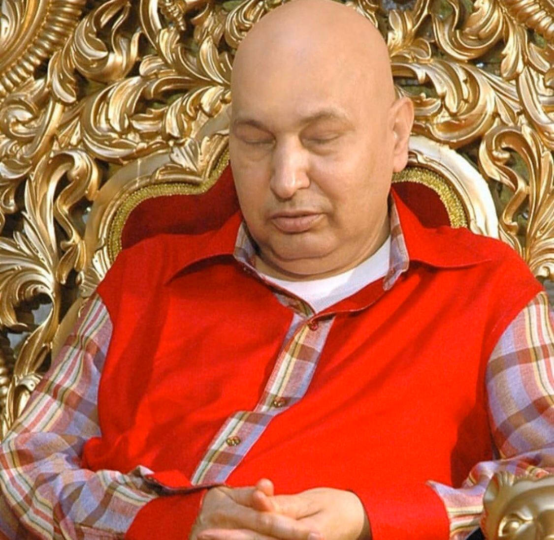 guru nanak dev ji 桌布 壁紙 — 一個光頭男人穿著紅色背心，閉著眼睛平靜地坐在華麗的金色王座上。