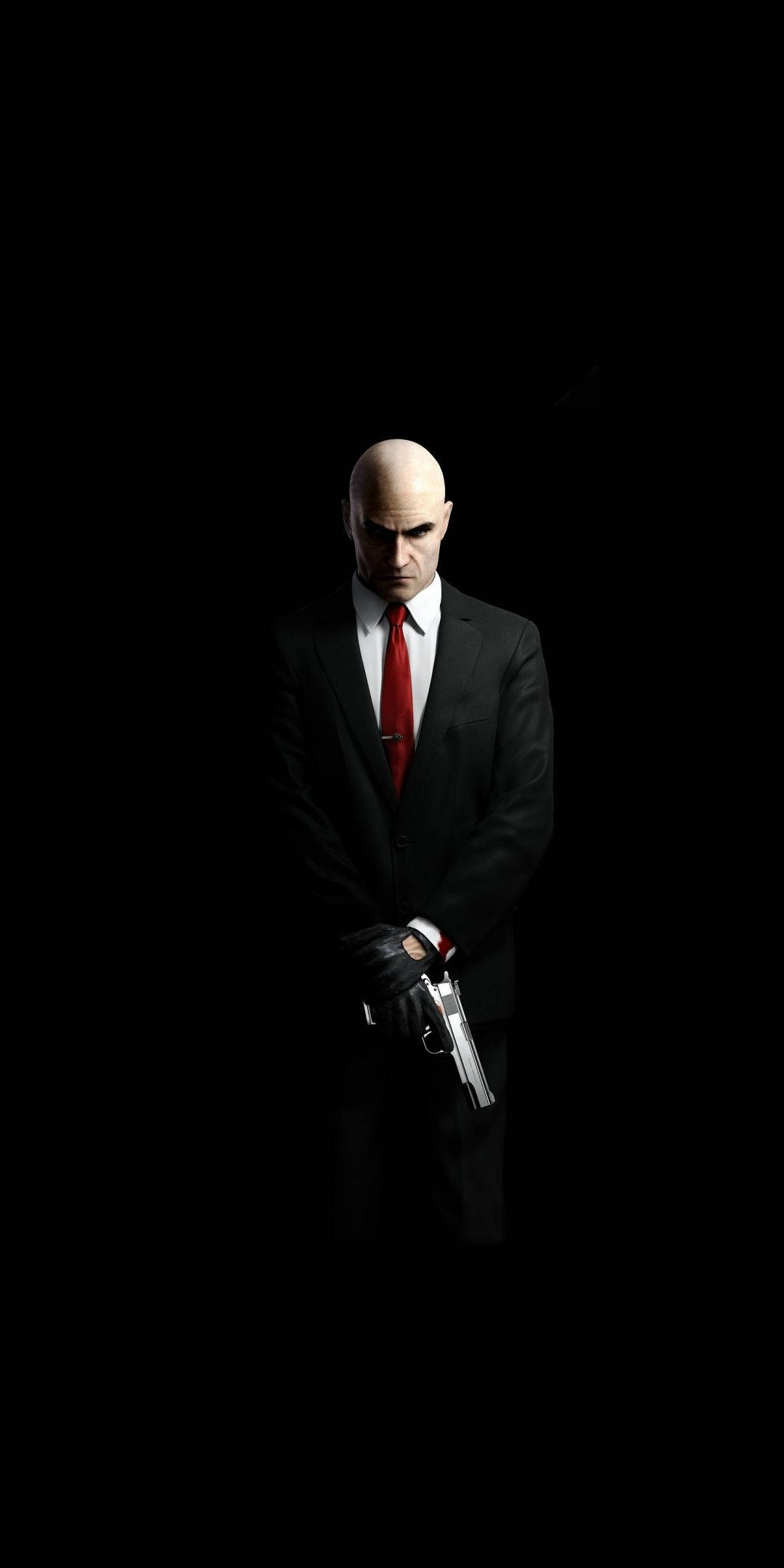 hitman iPhone 桌布 壁紙 — 一個光頭男人穿著黑色西裝和紅色領帶，在純黑背景前持槍。