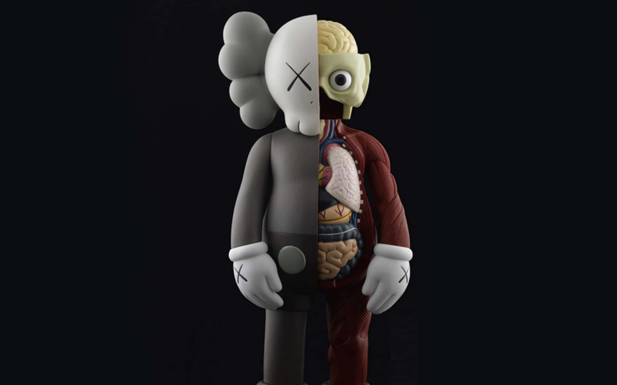 KAWS 桌布 壁紙 — 一個分裂的KAWS公仔在黑色背景上露出內臟，一側顯示頭骨，另一側顯示大腦和心臟。