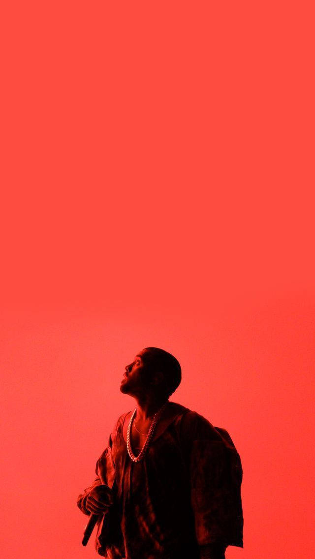 Kanye 桌布 壁紙 — 一個剪影中的男人向上凝視，背景是純粹的火紅色，手持麥克風。