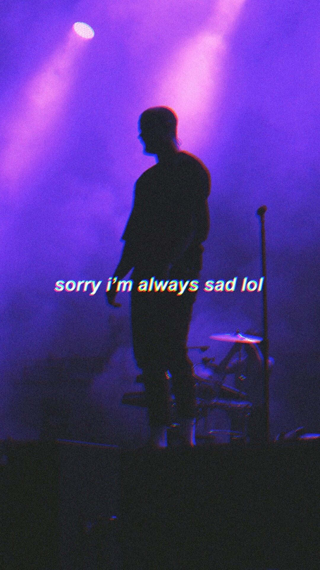 sadness 桌布 壁紙 — 一個剪影音樂家站在煙霧瀰漫、被紫色燈光籠罩的舞台上，文字疊加顯示「sorry i'm always sad lol」。