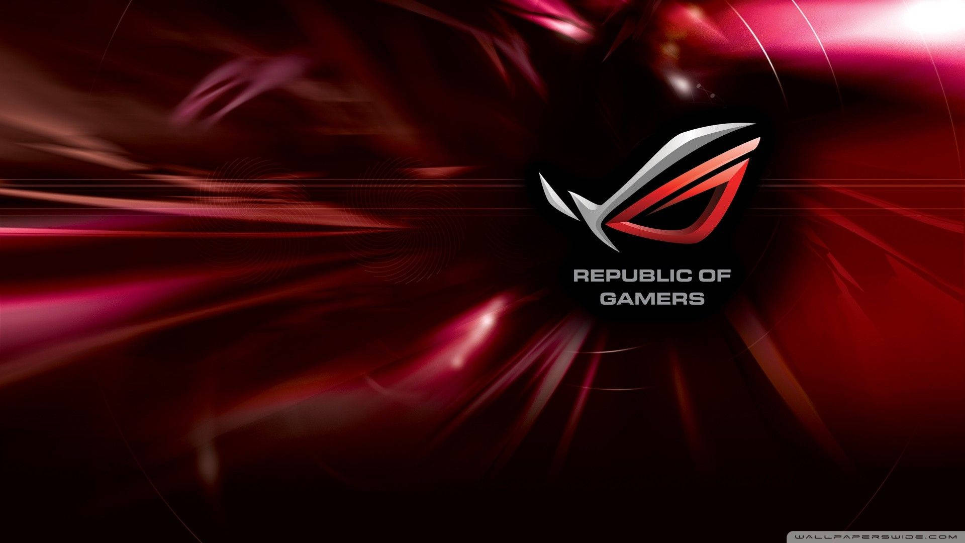 華碩 ROG 桌布 壁紙 — 一個動態的紅黑抽象背景，帶有圍繞 Republic of Gamers 標誌輻射的發光條紋。