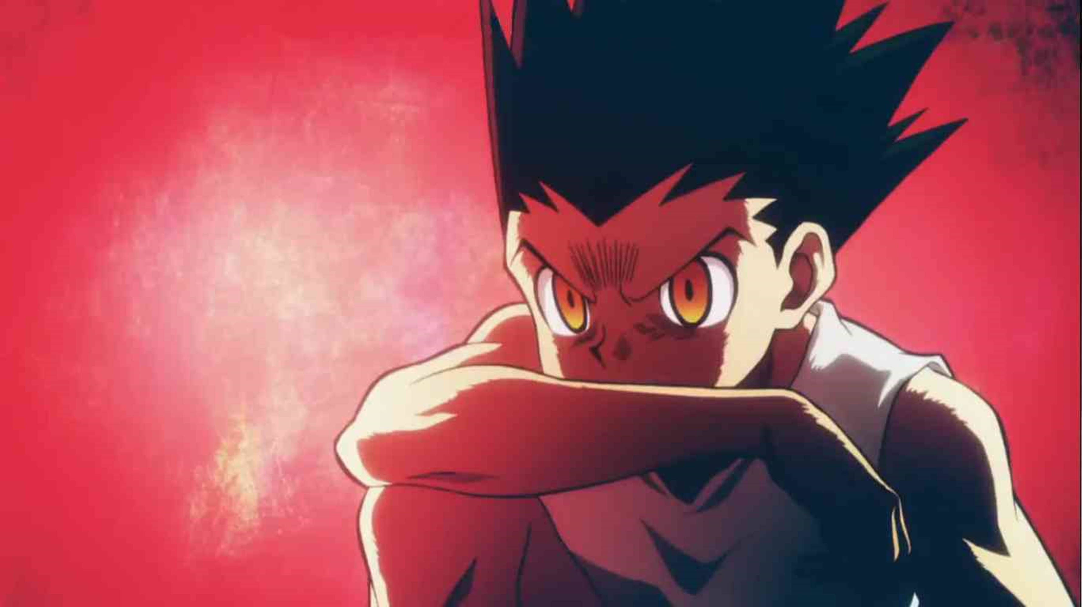 Hunter X Hunter 4K 桌布 壁紙 — 一個動漫男孩，有著刺蝟般的黑髮和發光的橙色眼睛，在紋理紅色的背景上強烈凝視。