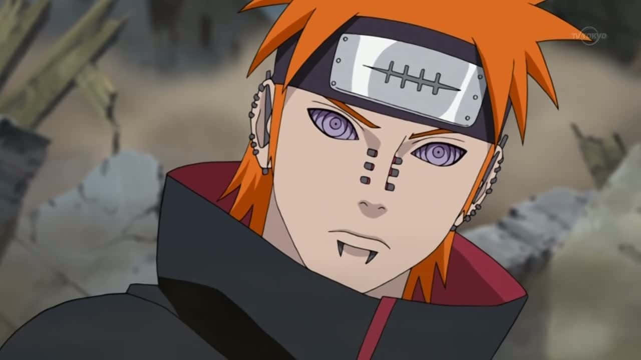 Nagato 桌布 壁紙 — 一個動漫角色，擁有尖刺的橙色頭髮、紫色眼睛和額頭護具，站在廢墟般的石頭環境中。