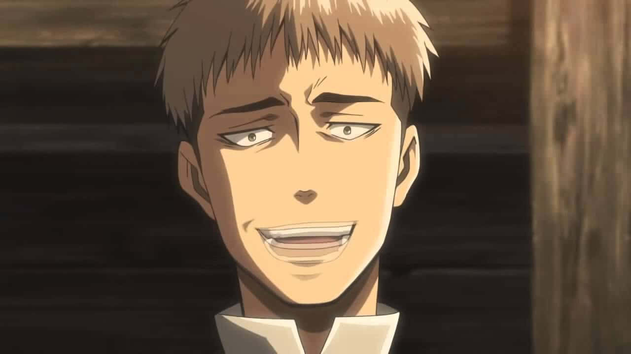 Jean Kirstein 桌布 壁紙 — 一個動漫角色的特寫，擁有尖刺金髮和咧嘴笑，背景是深色木質。