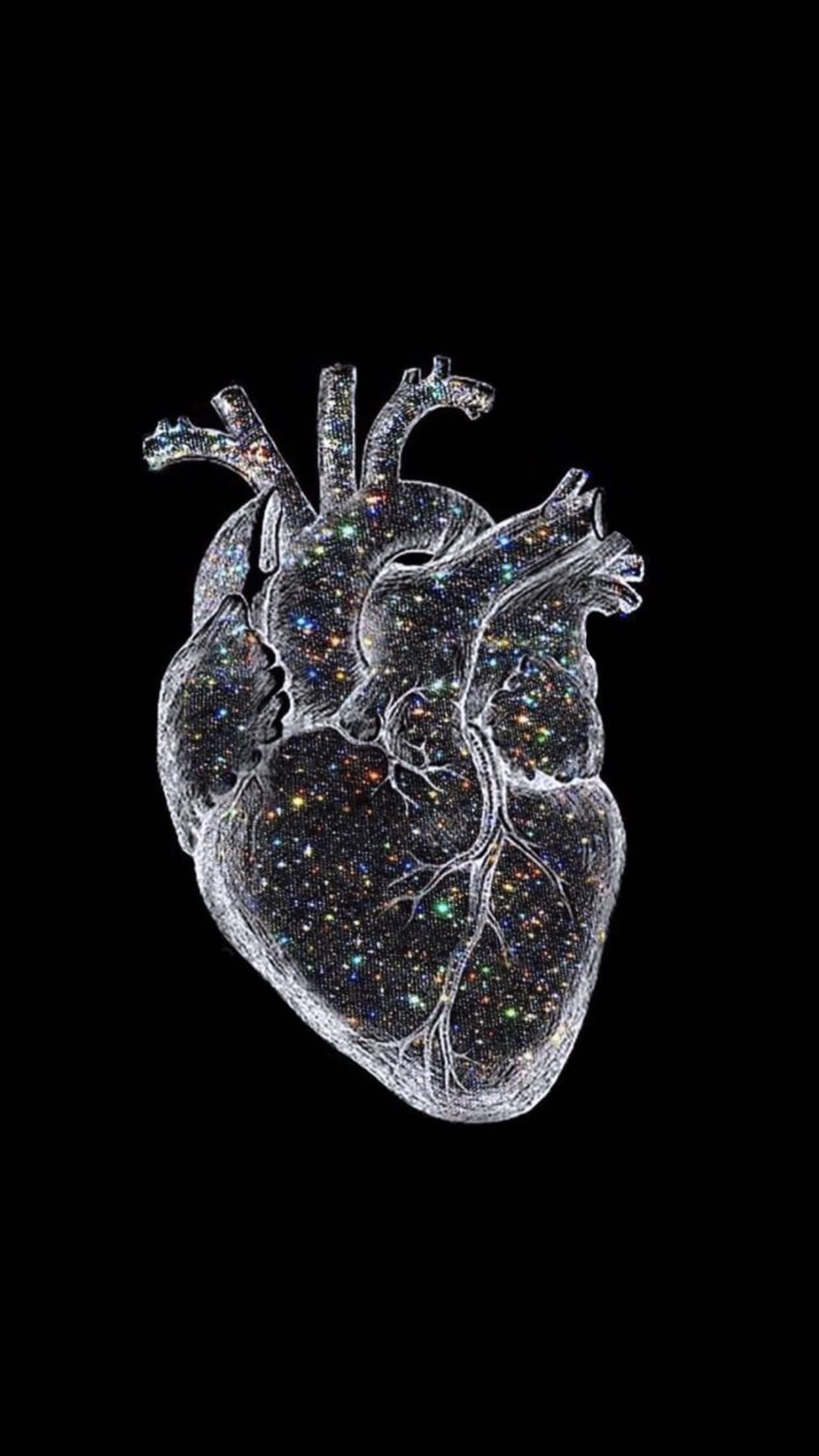 醫療 桌布 壁紙 — 一個半透明的解剖學心臟，裡面充滿閃爍的星星，背景是黑色。