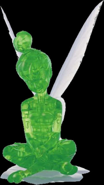 Peter Pan 桌布 壁紙 — 一個半透明綠色塑膠小雕像，描繪一位坐著的白翼仙女手持劍，孤立在黑色背景上。