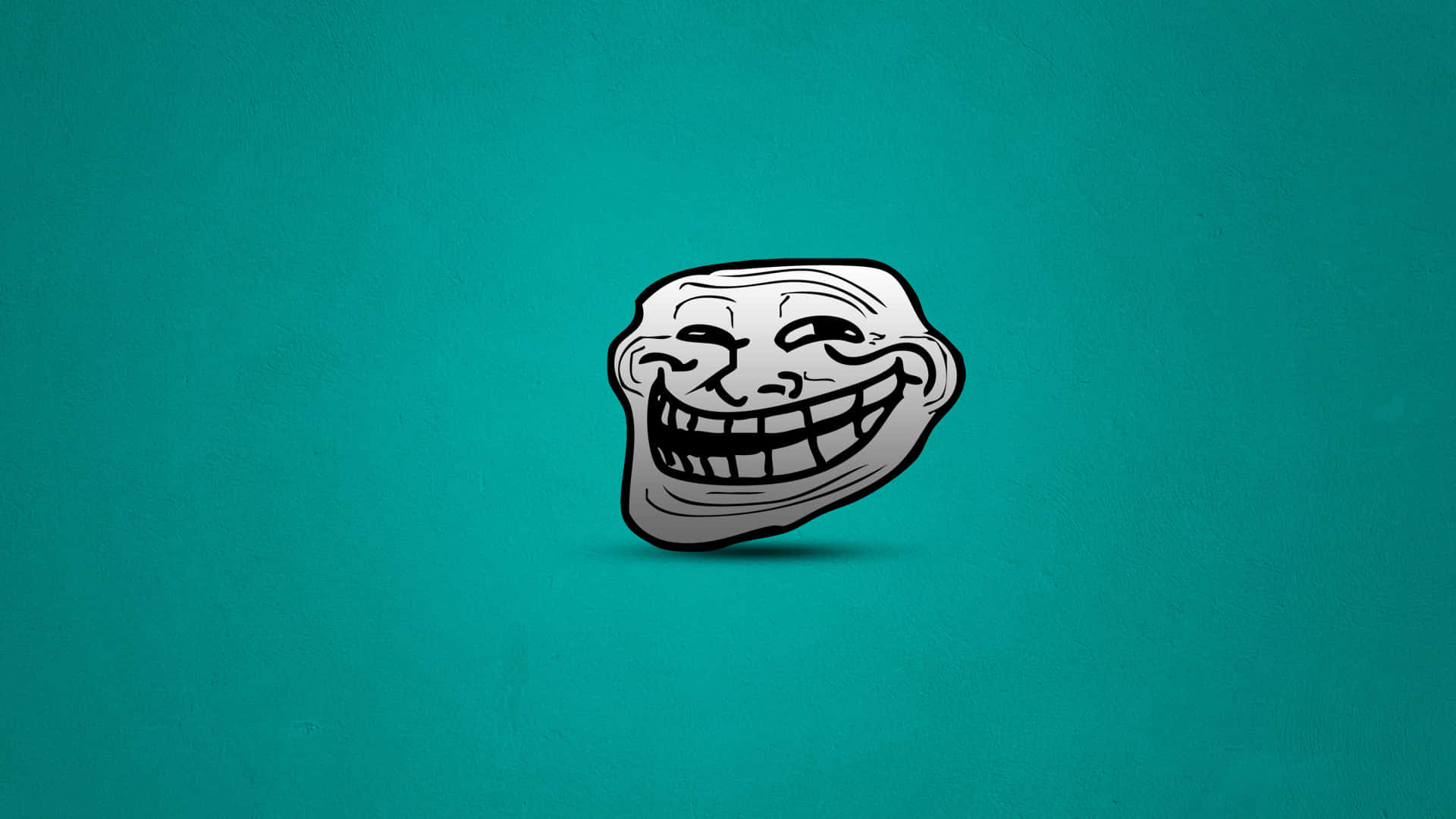 Memes 桌布 壁紙 — 一個卡通巨魔臉，咧嘴大笑，瞇著眼睛，居中在帶紋理的青綠色背景上。