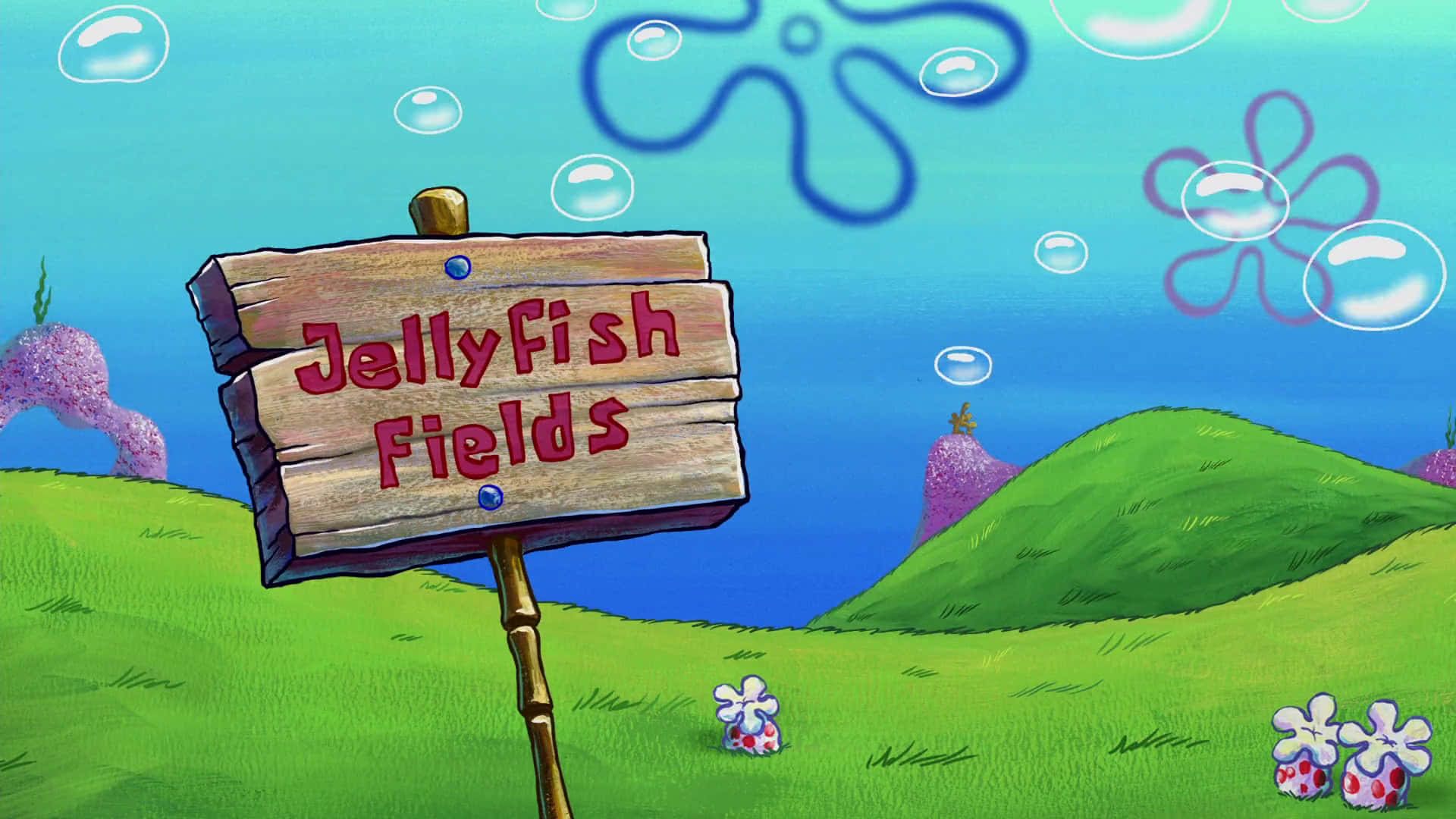 Jellyfish Fields 桌布 壁紙 — 一個卡通木牌寫著「Jellyfish Fields」，矗立在充滿活力的水下草地，有綠色山丘和漂浮的氣泡。