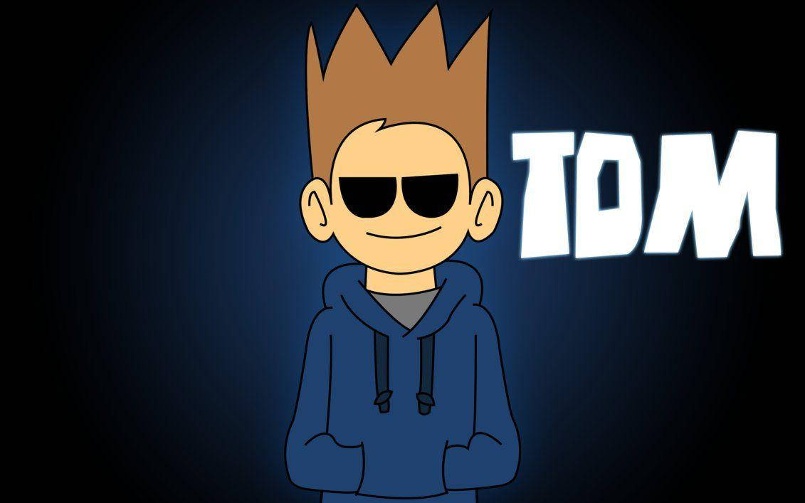 Eddsworld 桌布 壁紙 — 一個卡通角色，擁有尖刺的棕色頭髮和太陽眼鏡，穿著藍色連帽衫，背景是深藍色漸變，名字TOM以發光的白色字母呈現。