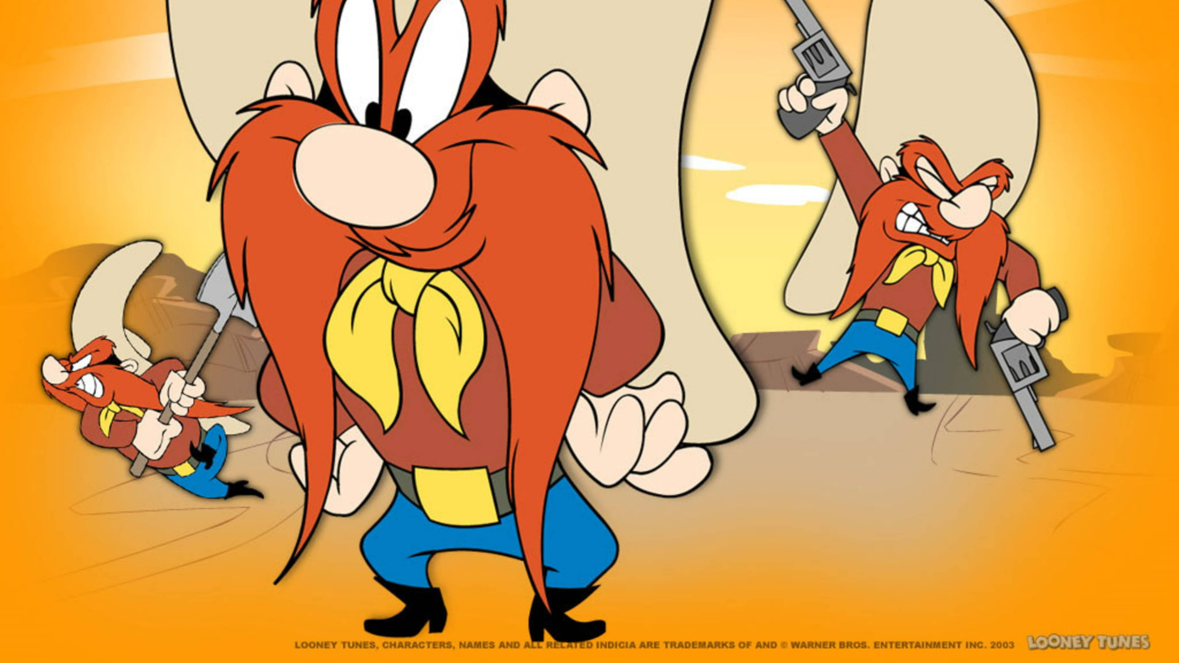 Yosemite Sam 桌布 壁紙 — 一個卡通角色，長著紅色長鬍鬚，戴著黃色頭巾，自信地站在沙漠場景中，手持槍和鎬，背景中有他較小的版本。