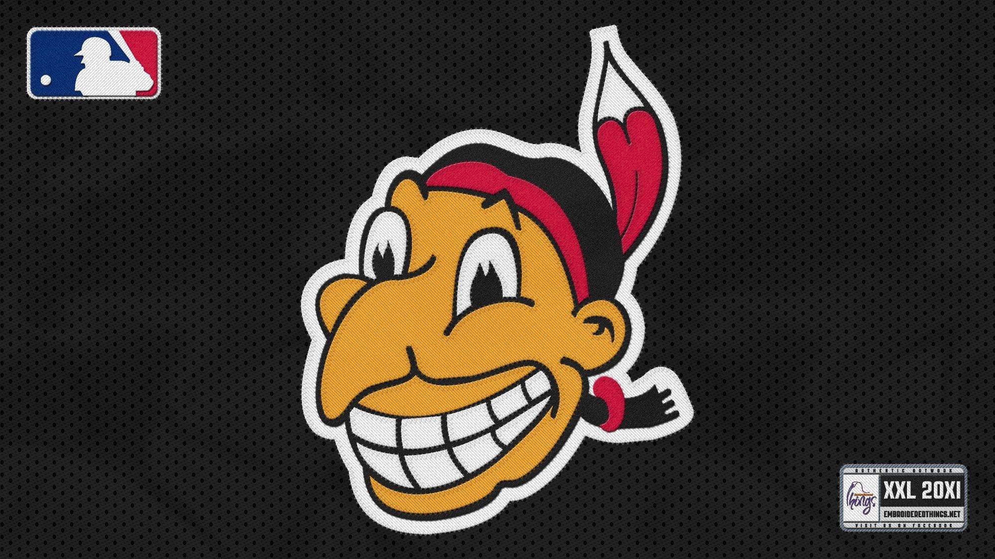Cleveland Indians 桌布 壁紙 — 一個卡通風格微笑的吉祥物，戴著紅色頭帶和羽毛，背景是黑色網格。