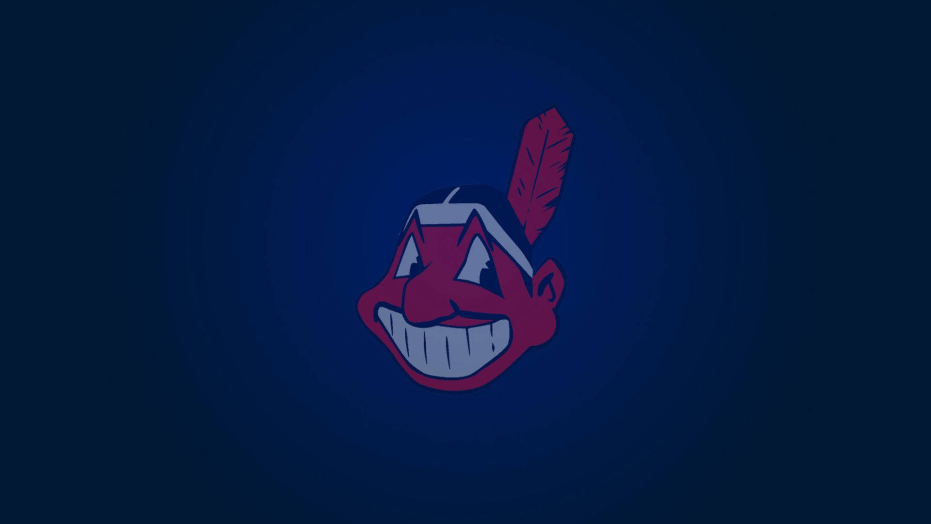 Cleveland Indians 桌布 壁紙 — 一個卡通風格的紅色臉孔，戴著羽毛頭飾，在深藍色漸層背景上微笑。