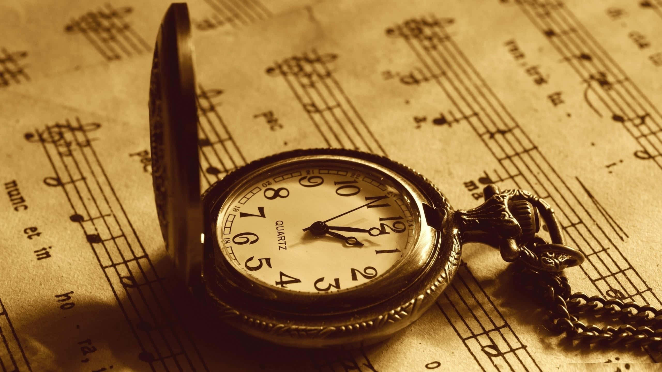Time 桌布 壁紙 — 一個古董懷錶打開放在泛黃的樂譜上，沐浴在溫暖的棕褐色光線中。