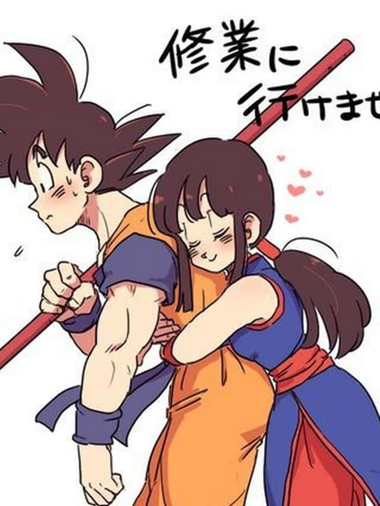 龍珠 桌布 壁紙 — 一個可愛的動漫女孩從後面擁抱一個拿著法杖的男孩，兩人都臉紅，附近有愛心漂浮。