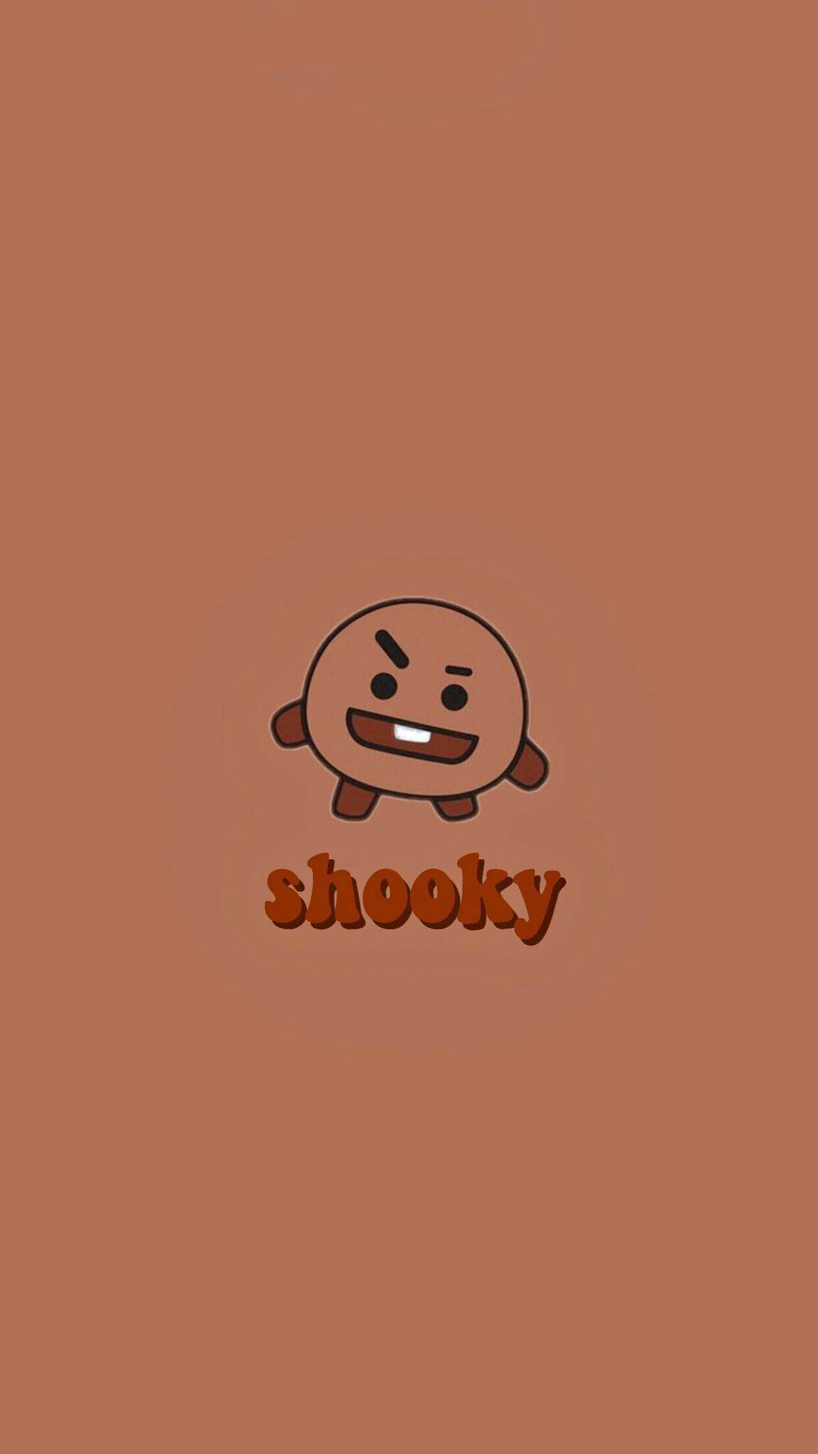shooky bt21 桌布 壁紙 — 一個可愛的卡通角色叫shooky，帶著一副不高興的表情，站在純棕色背景的中央。