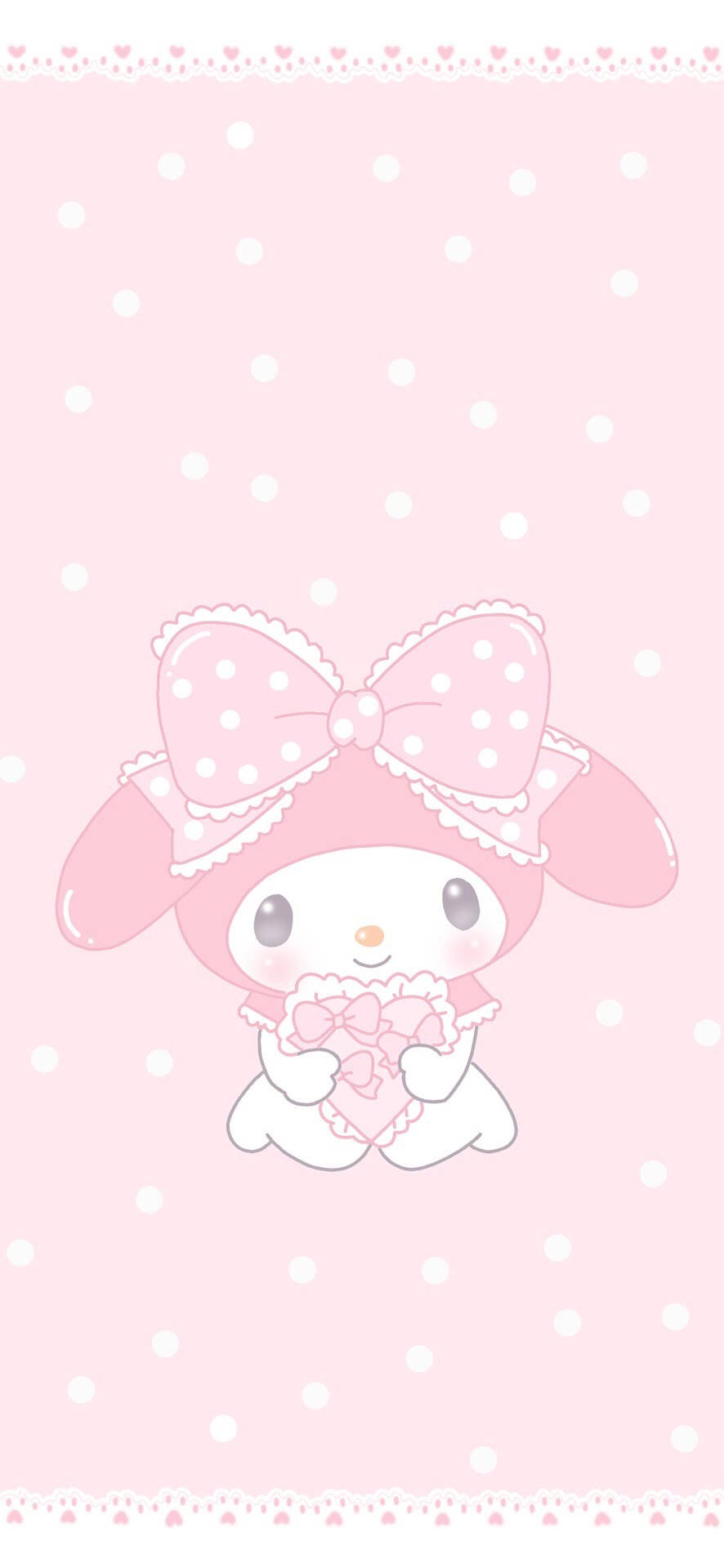 My Melody在圓點背景前拿著粉紅色心形。 — 柔和美學 GIF 壁紙